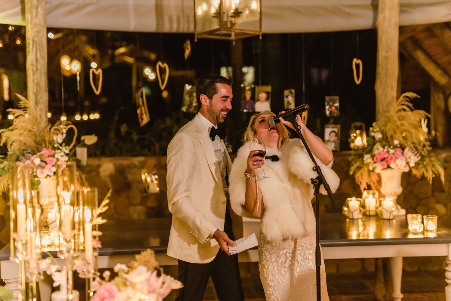 Rustic wedding reception venue decorated with warm lighting and candles creating an intimate atmosphere.