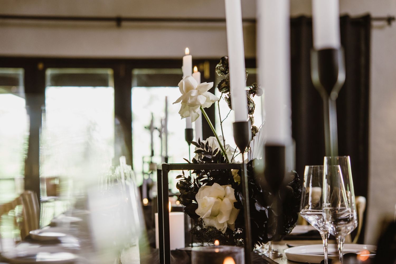 Modern reception venue with white columns and natural lighting streaming through windows.