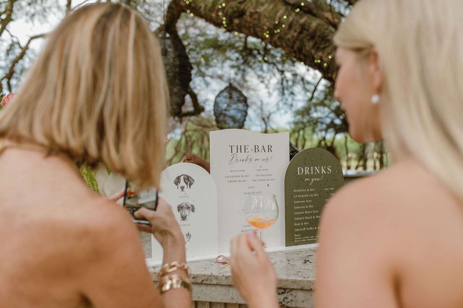 Wedding signage and decorative details displayed at an outdoor celebration.