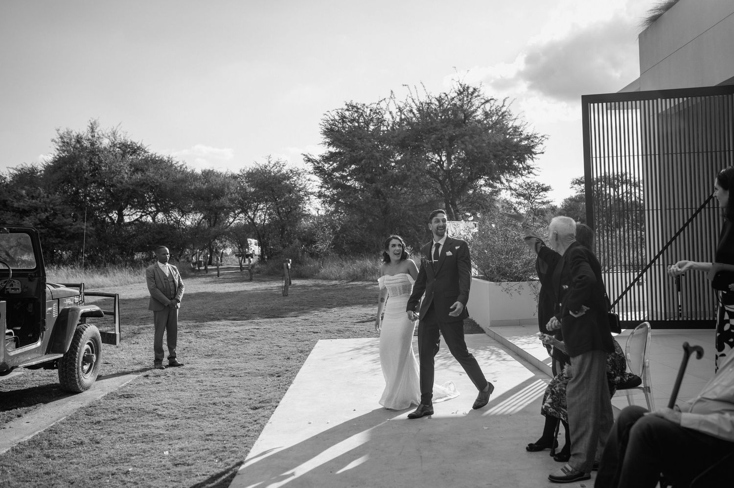 Black and white sequence showing wedding guests mingling in an outdoor setting.