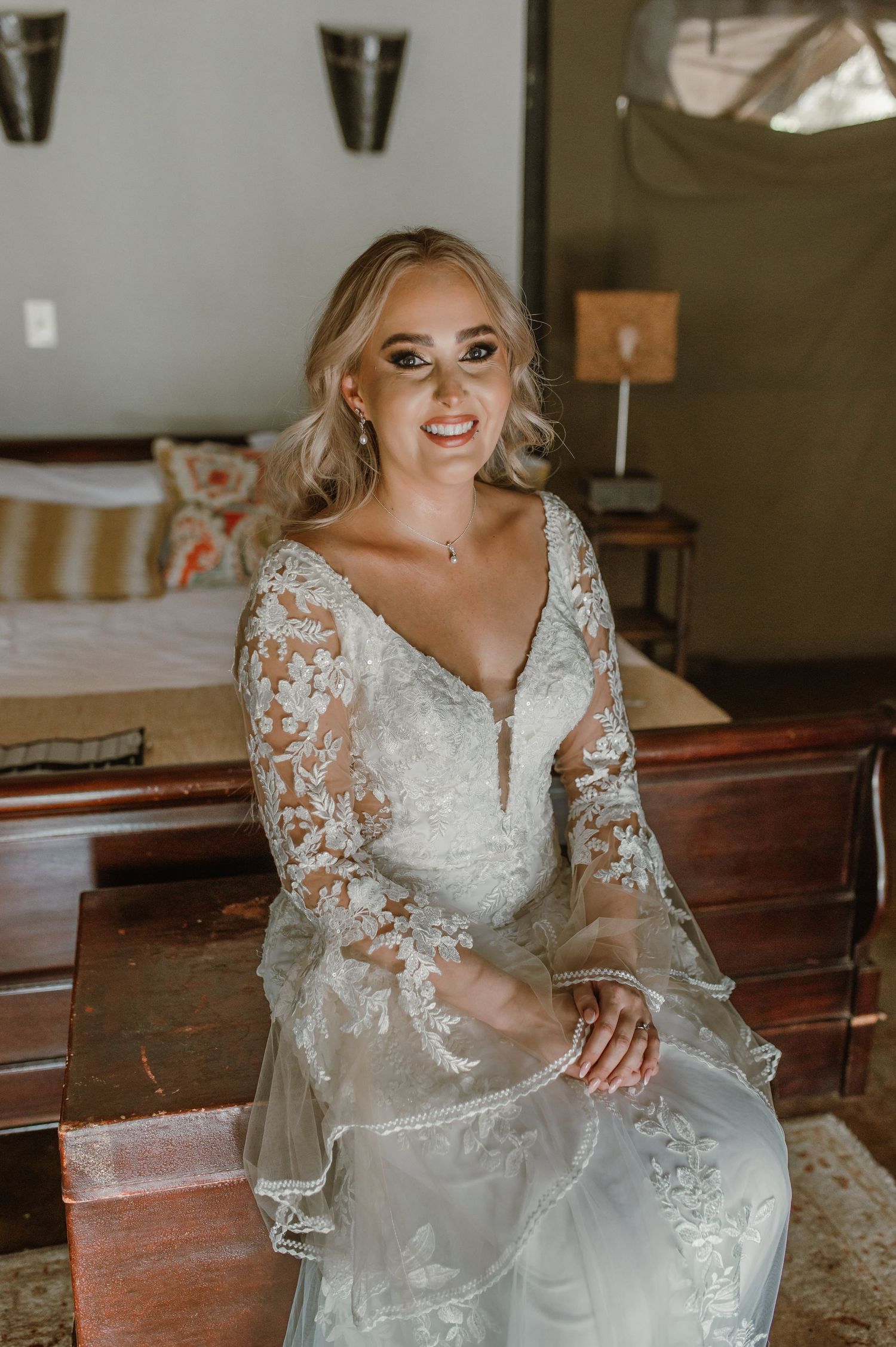 An elegant bridal portrait showcasing a lace wedding dress with sheer sleeves.