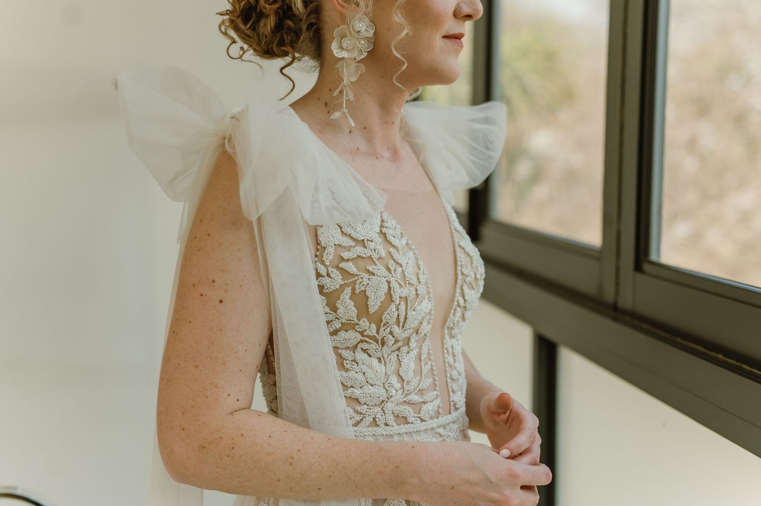 Elegant bridal portrait showing intricate lace details of a wedding gown.