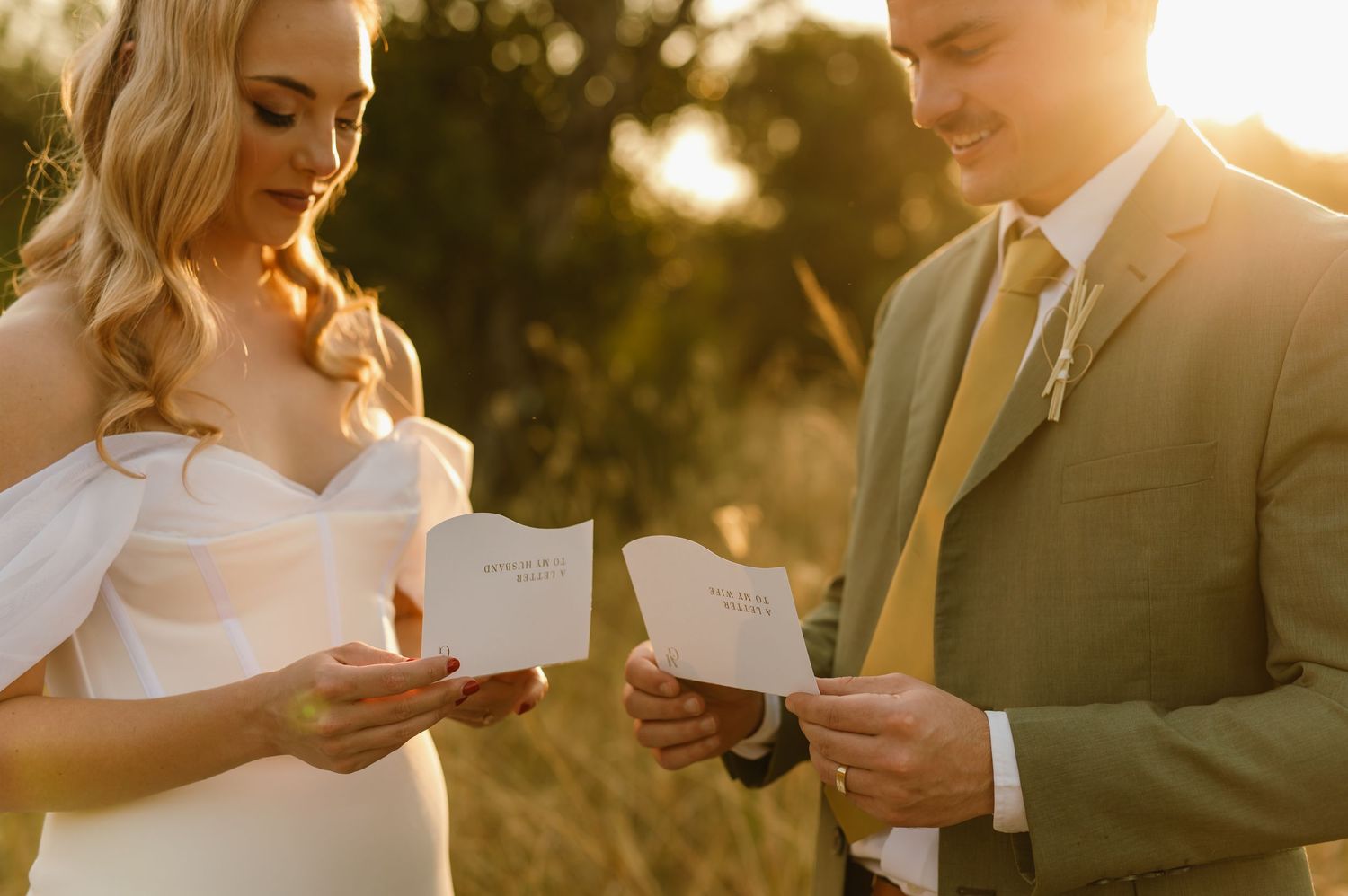 Couple sharing a tender moment while reading letters to each other during their wedding ceremony.