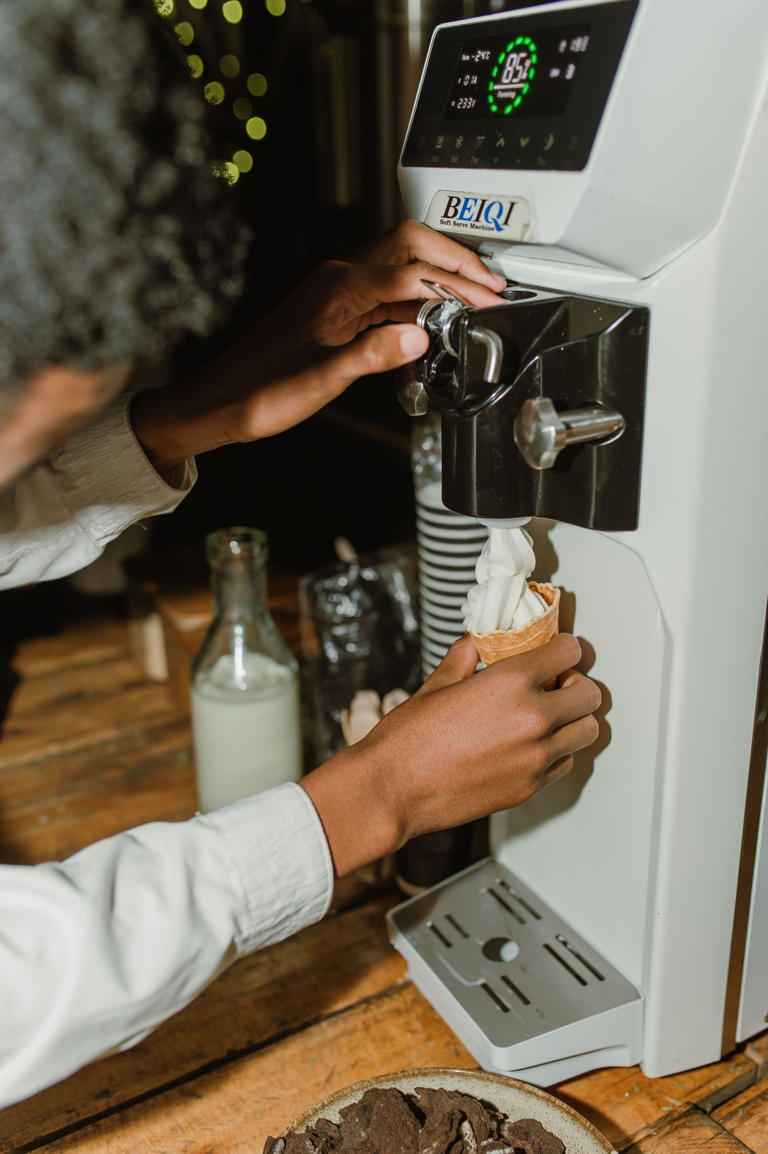 Close-up of hands operating a professional coffee machine at a wedding reception.