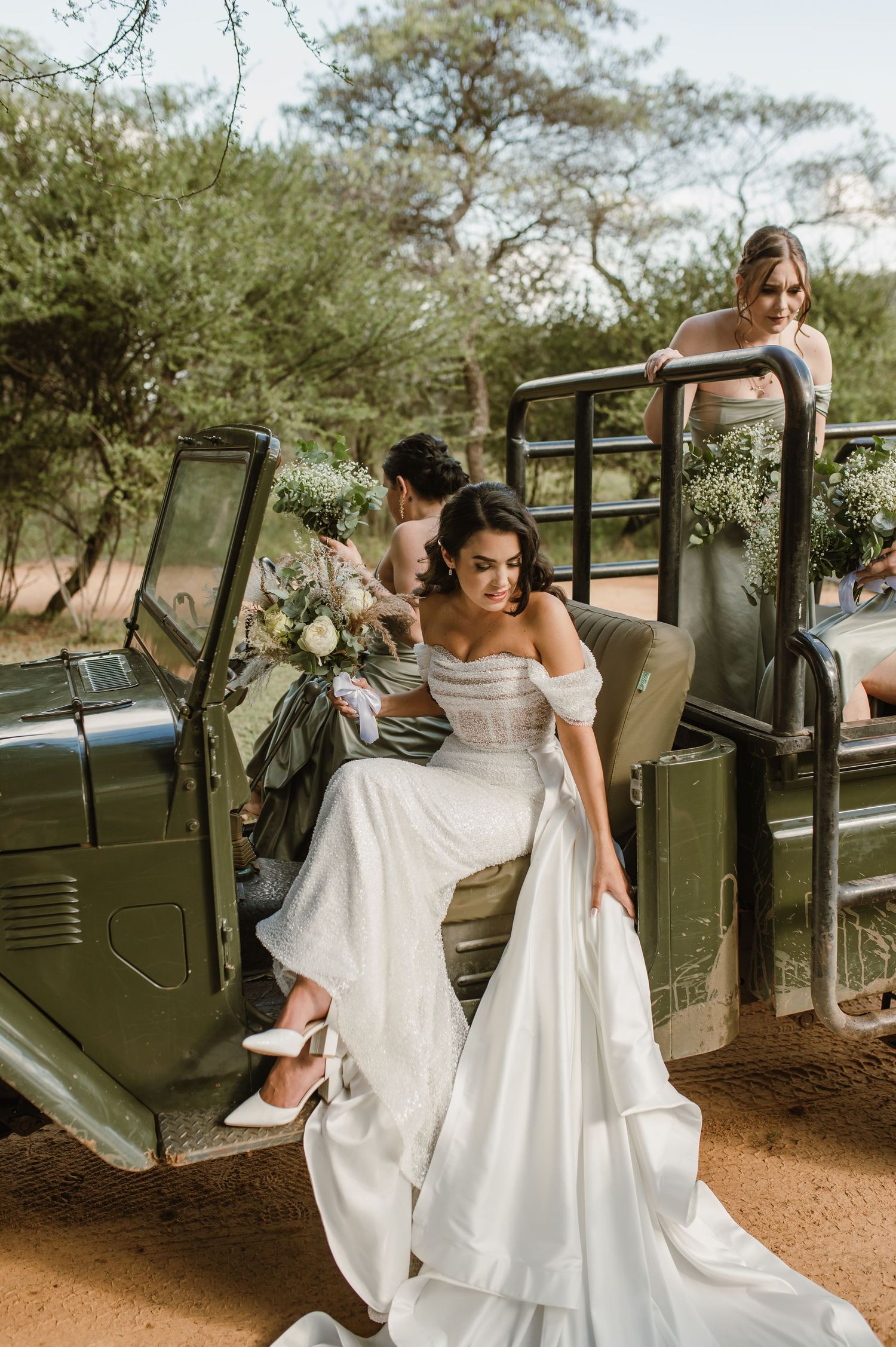 Bridal photoshoot featuring a classic military vehicle in a rustic outdoor setting.
