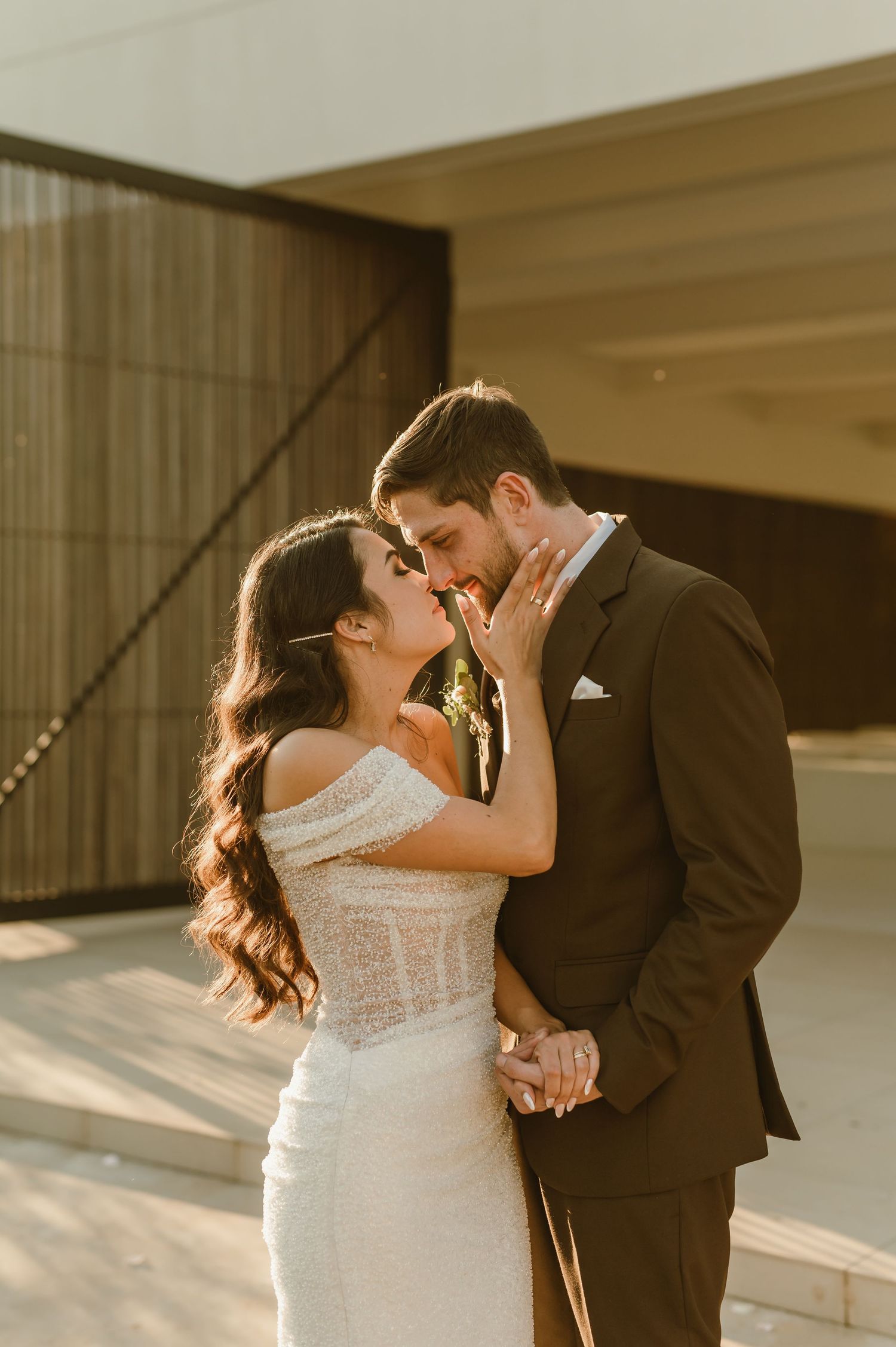 Romantic couple shares intimate moments during golden hour wedding photoshoot.