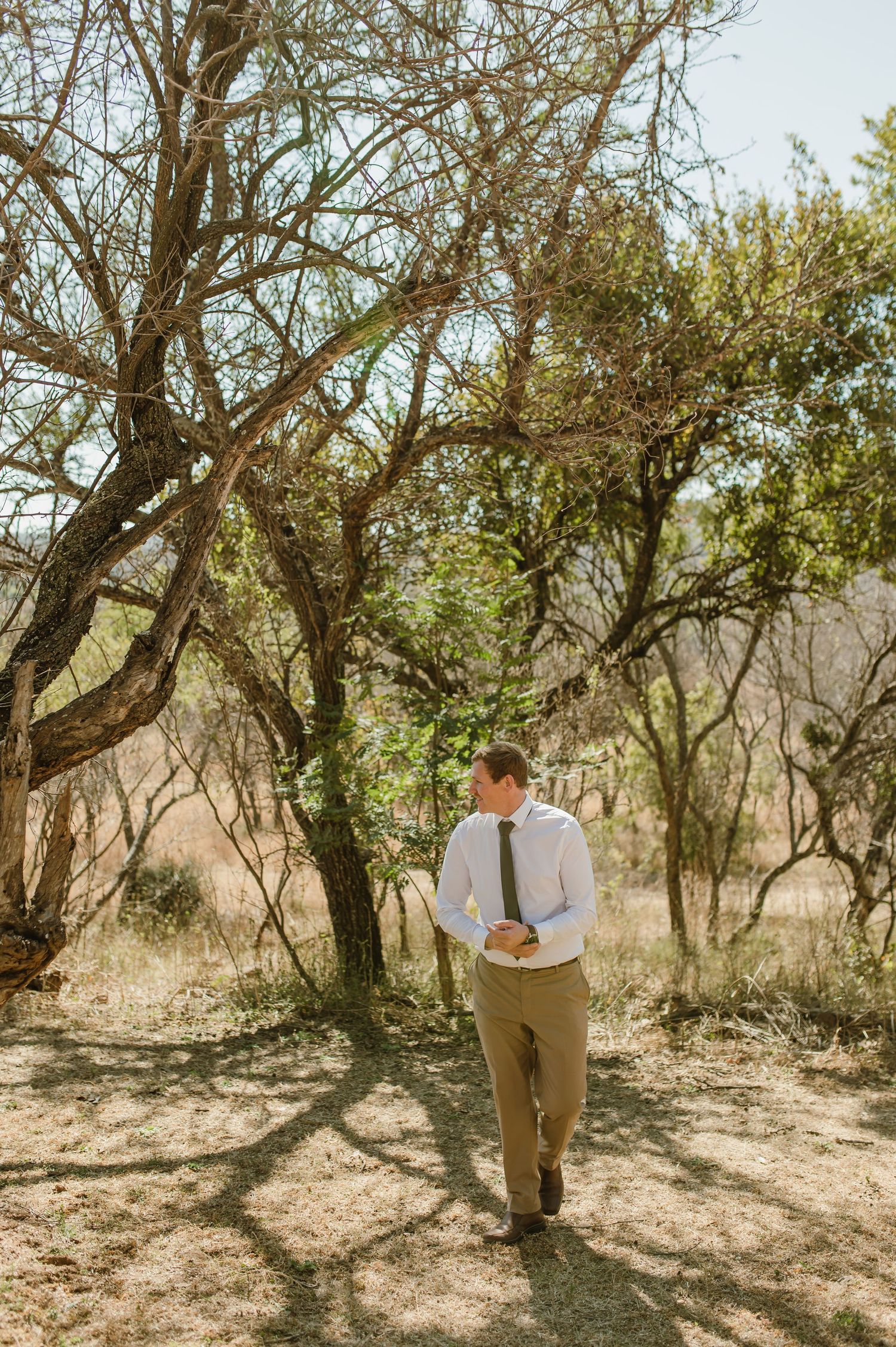 Safari lodge wedding photos with natural bushveld backdrop and dappled sunlight.