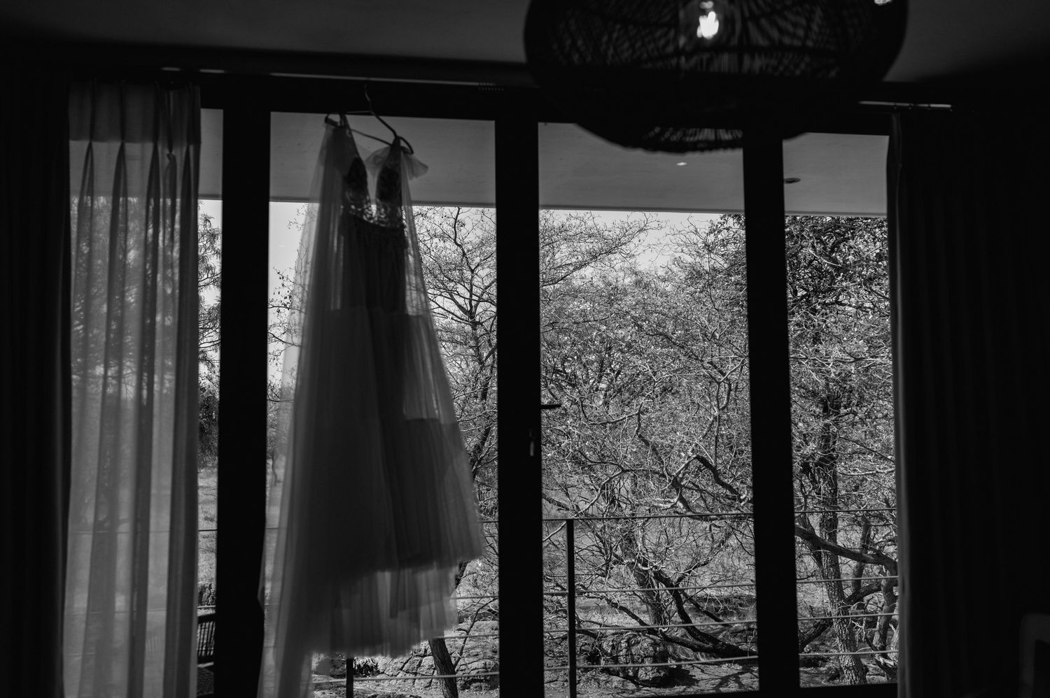 Modern interior space with large windows and natural light for wedding preparations.