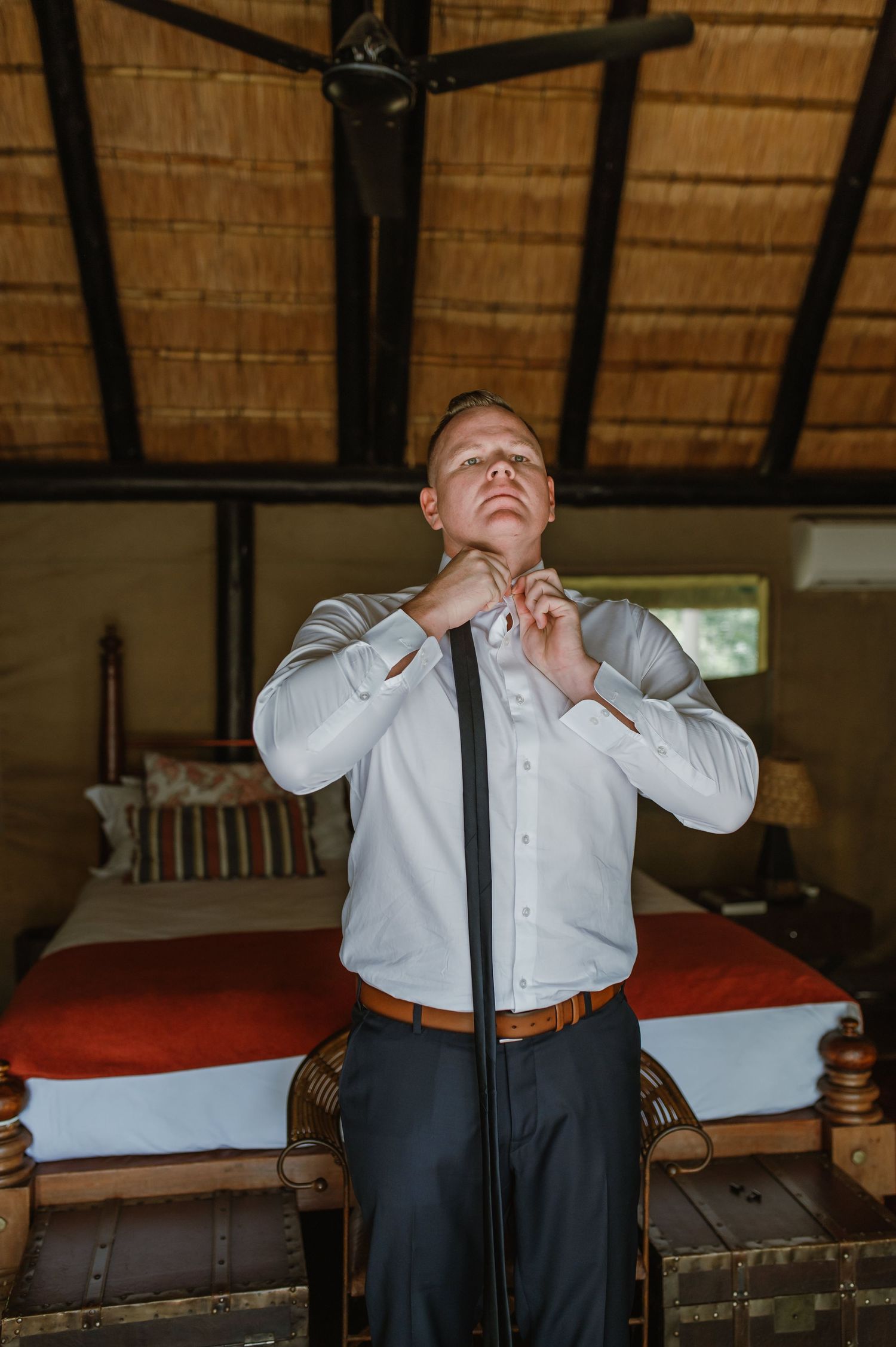 Series of expressive moments captured in rustic room with thatched roof.