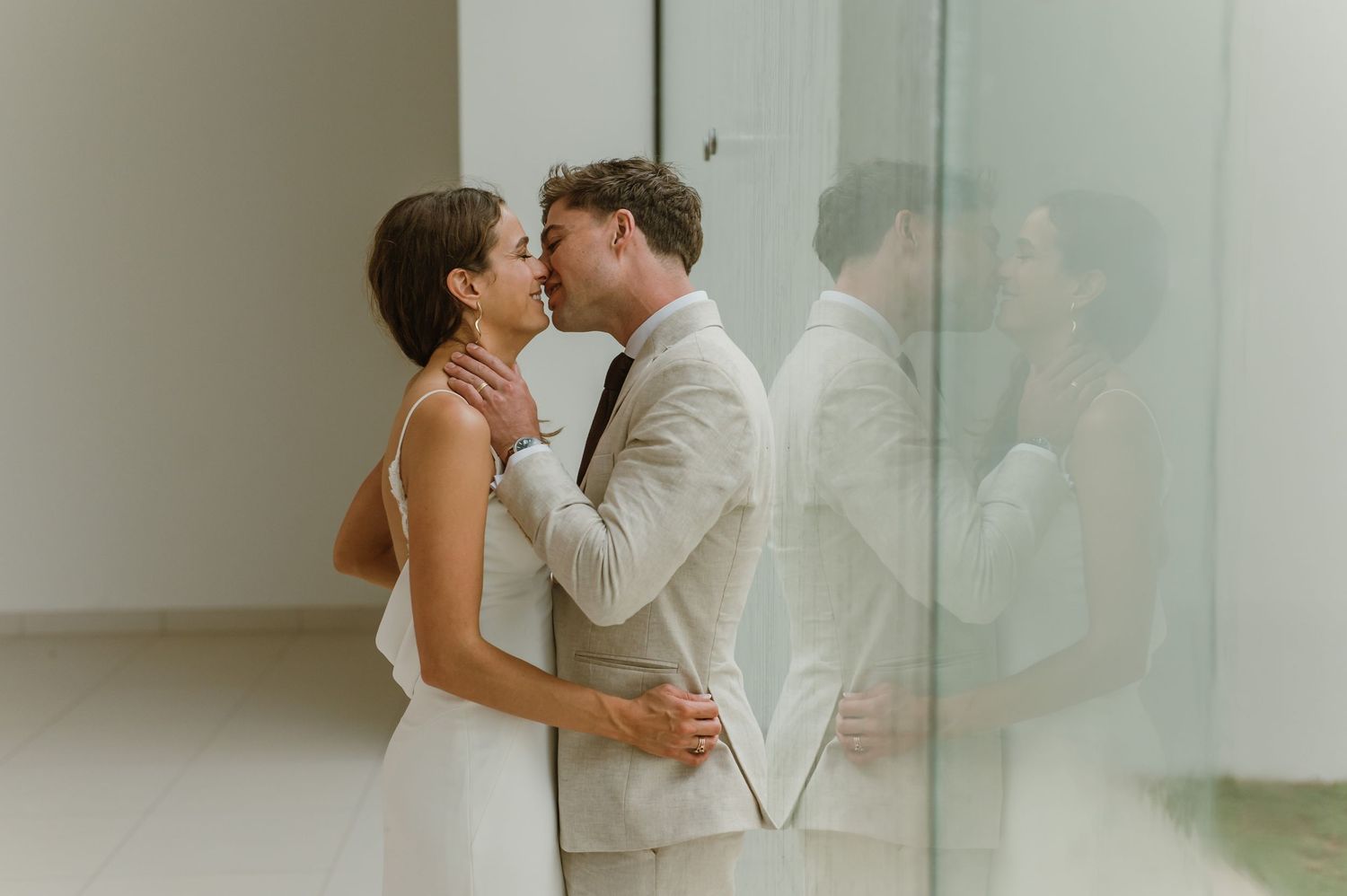 Modern wedding photography sequence showing romantic moments in a minimalist setting.