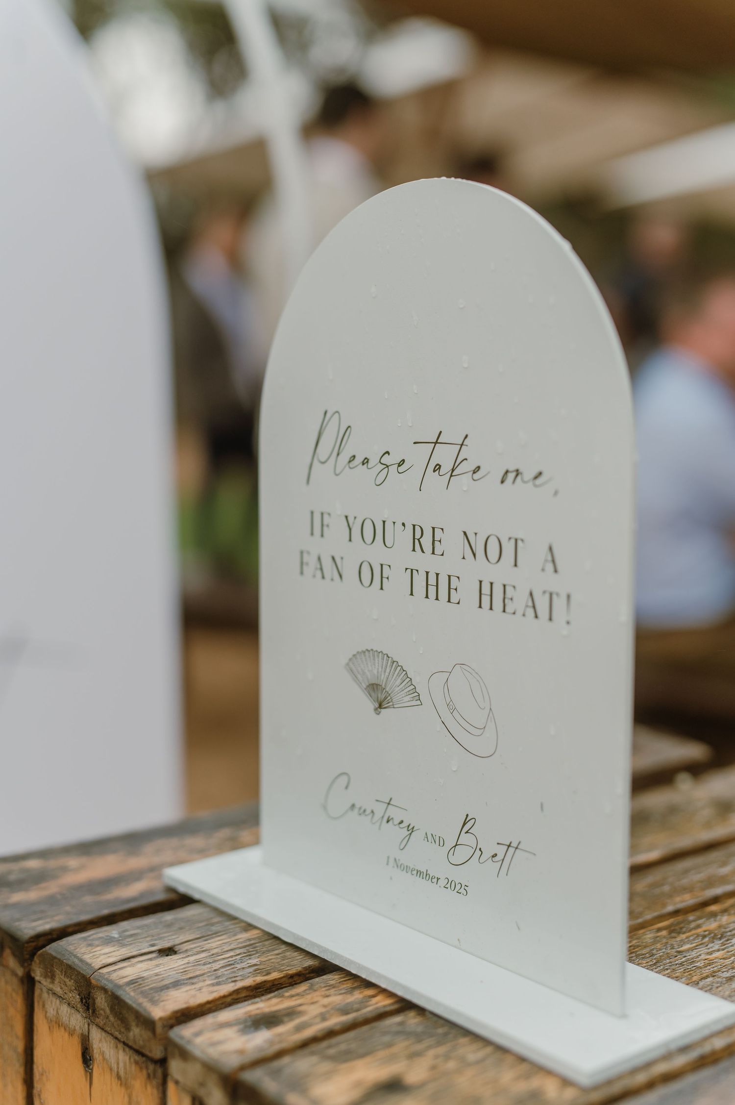 Decorative wedding signs displayed on rustic wooden surface with elegant calligraphy text.