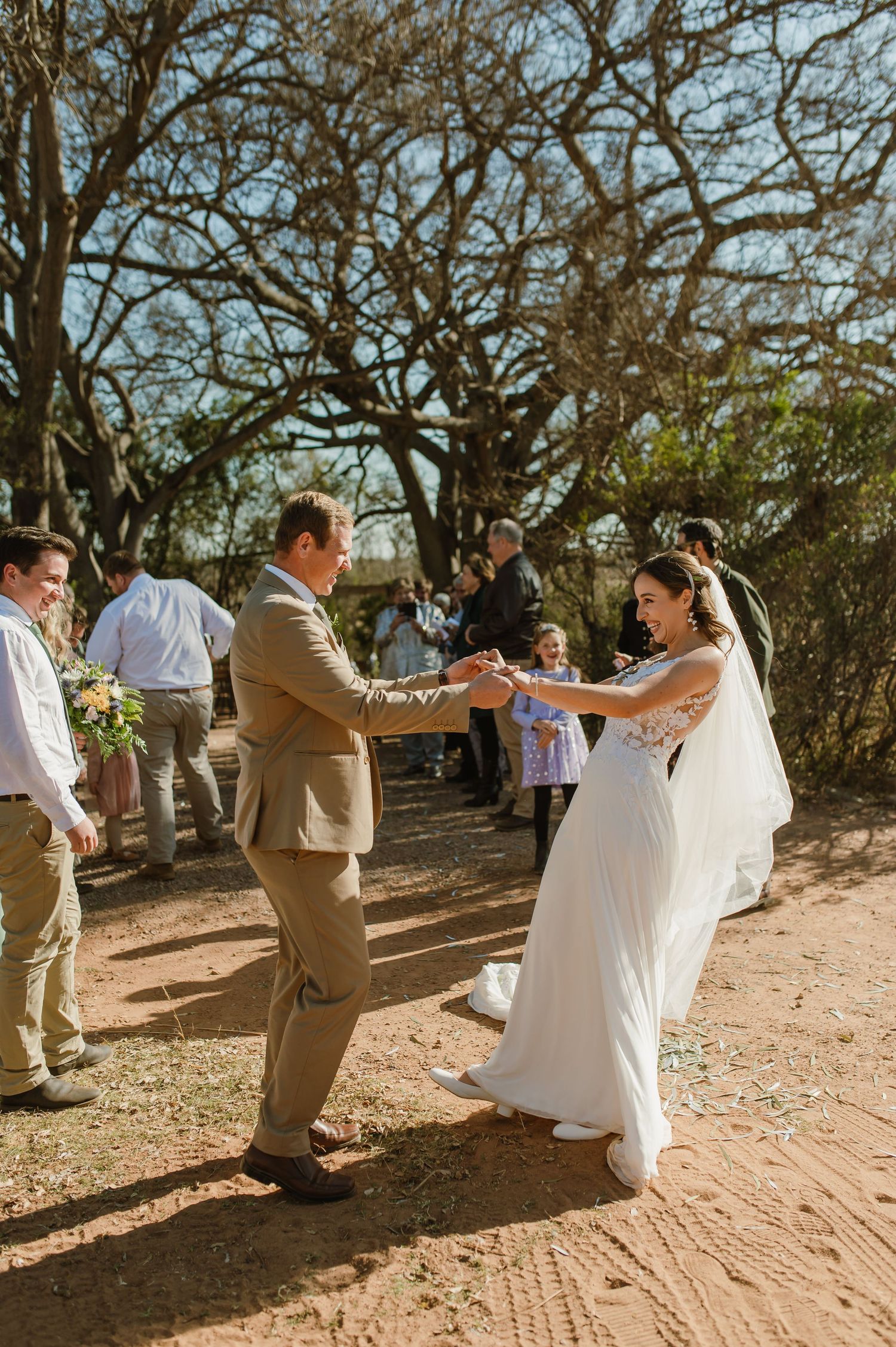 Wedding dance sequence captured in a rustic outdoor setting with natural lighting.