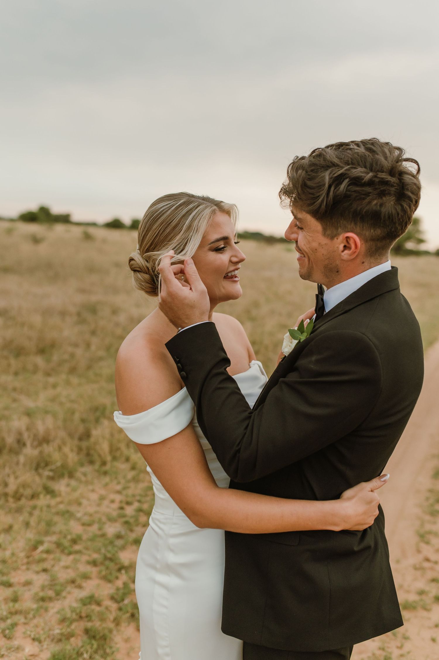 Sunset wedding photos capturing tender embraces between a couple in formal attire.