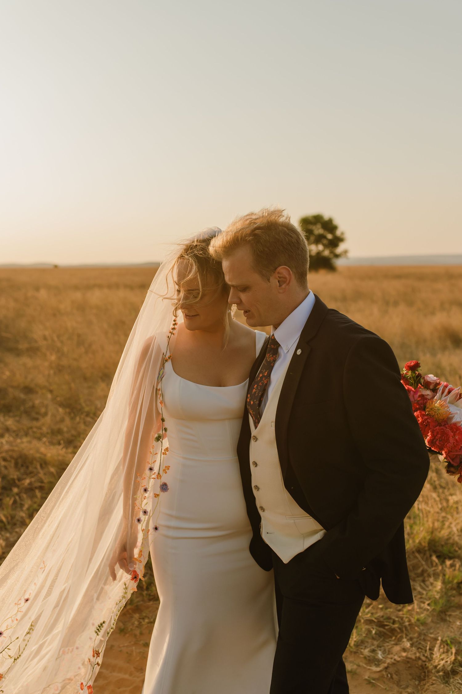 Intimate wedding portraits at golden hour showing tender moments between newlyweds.