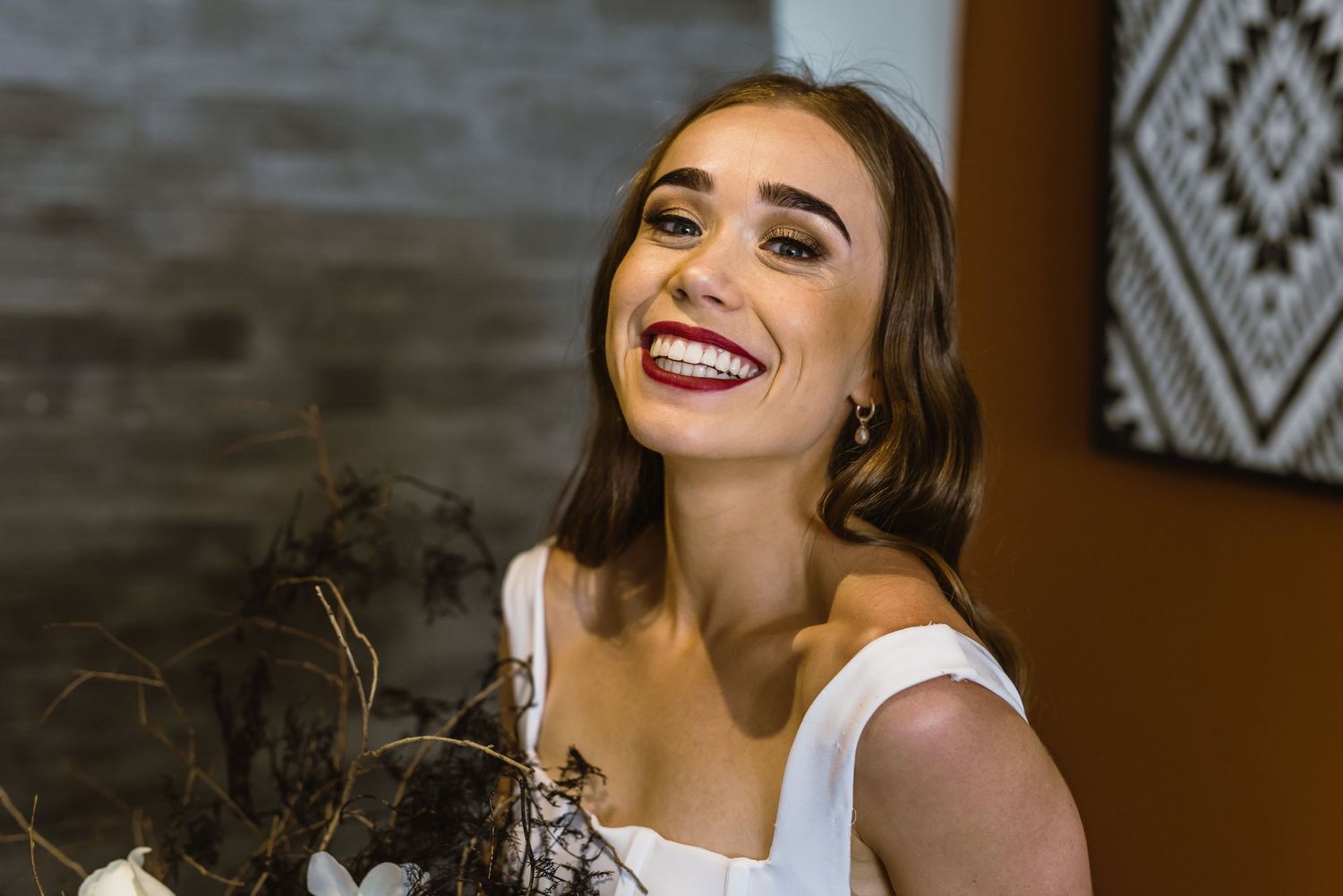 Modern bridal portrait showcasing elegant makeup and a sophisticated white gown.