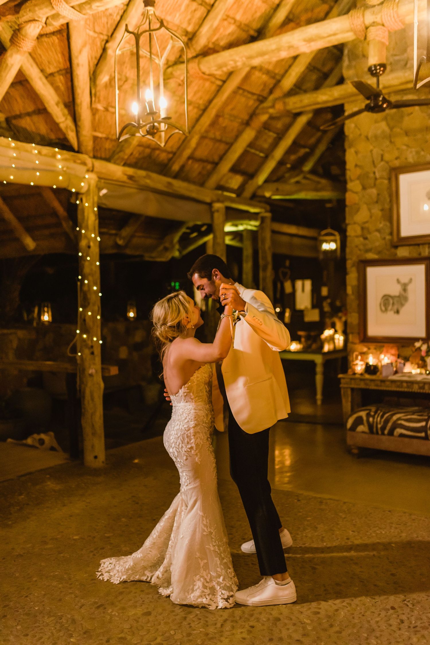 Dancers move gracefully across a rustic barn floor under warm lighting and wooden beams.