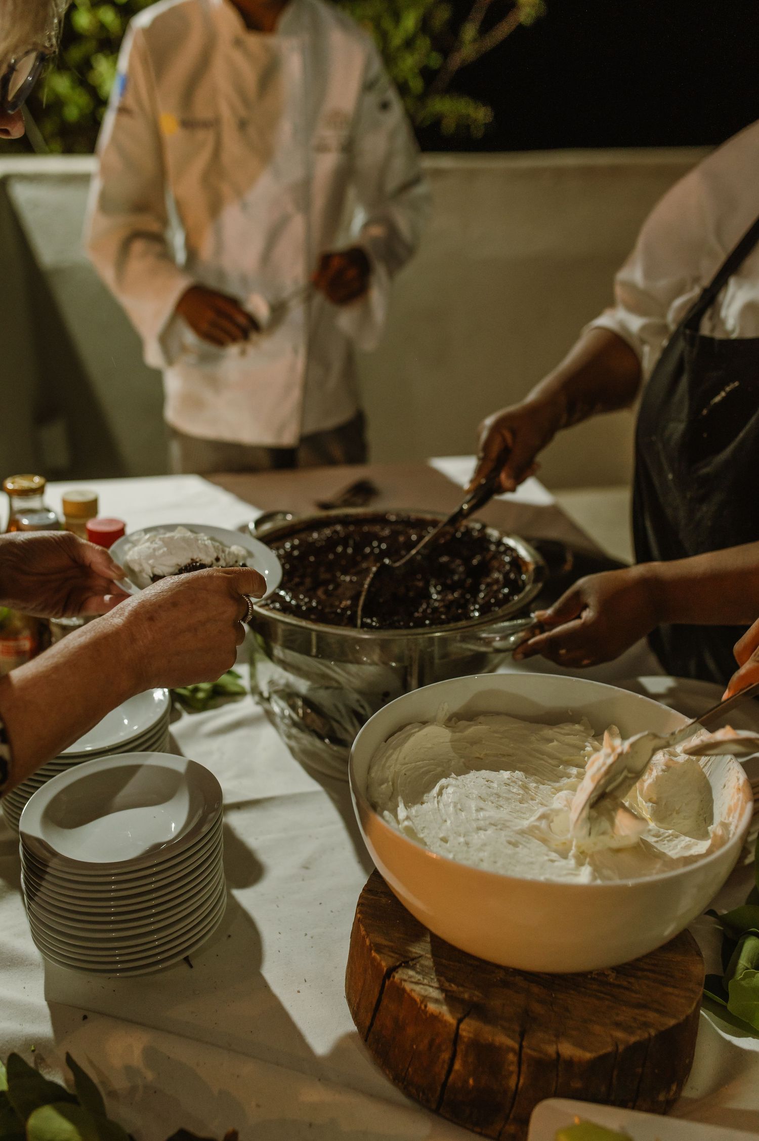 Food preparation station with bowls of ingredients and stacked plates.