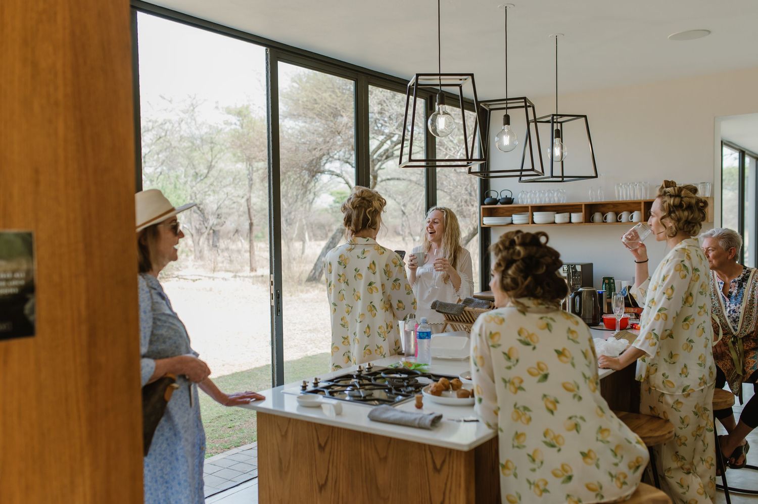 Bright open-concept kitchen and dining area with wood accents and large windows.
