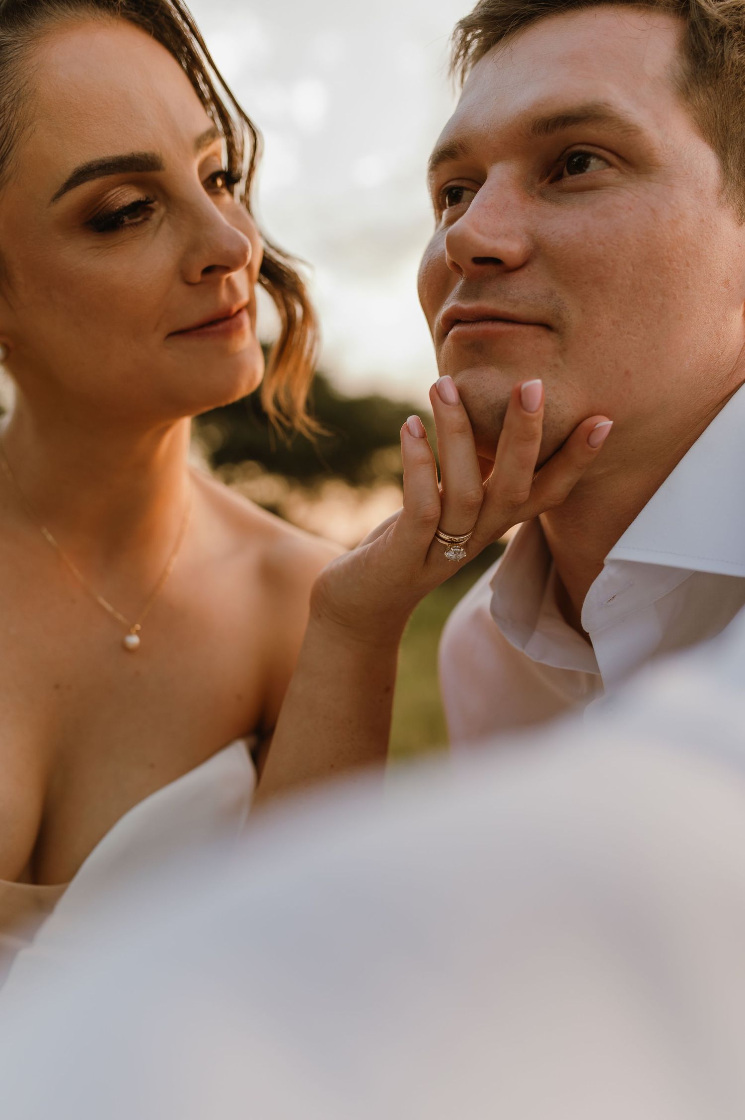 Close-up artistic wedding photos showing intimate moments between newlyweds during golden hour.