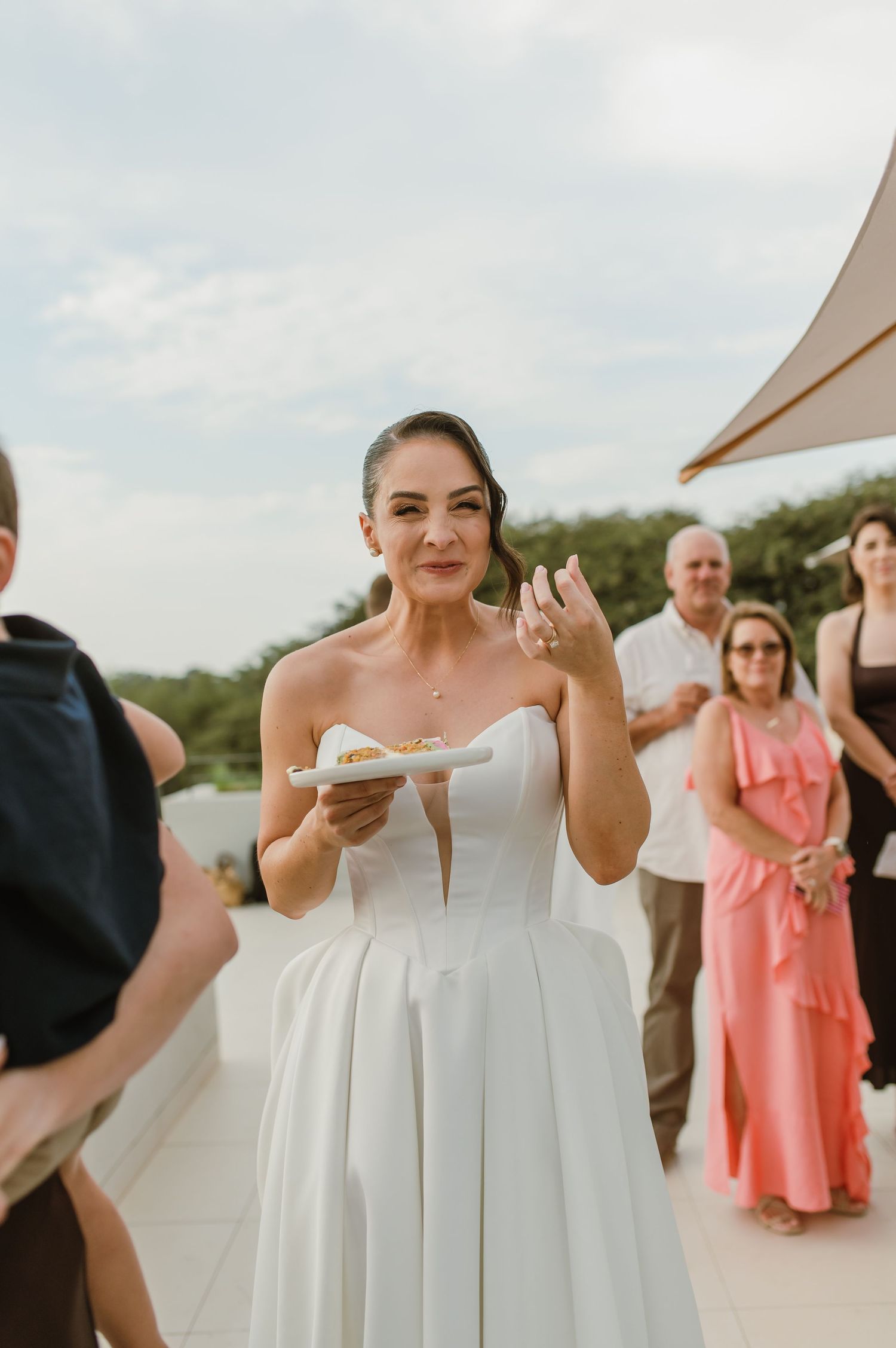 Wedding celebration with guests in formal attire enjoying an outdoor reception.