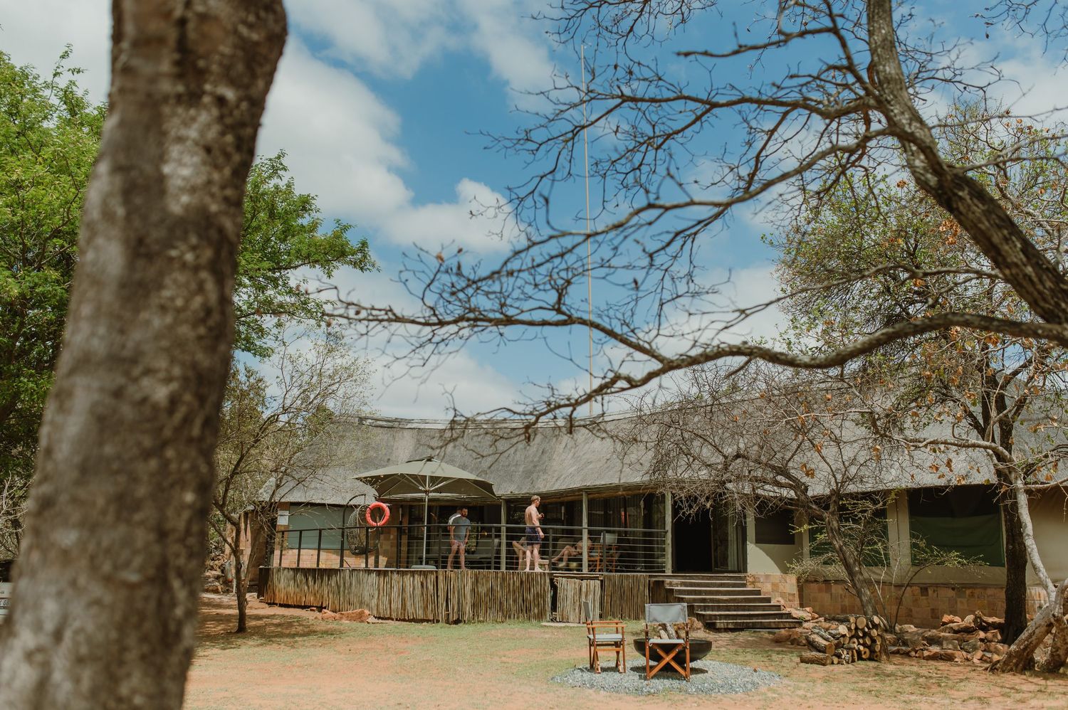 Outdoor view of a rustic building with trees and blue sky.
