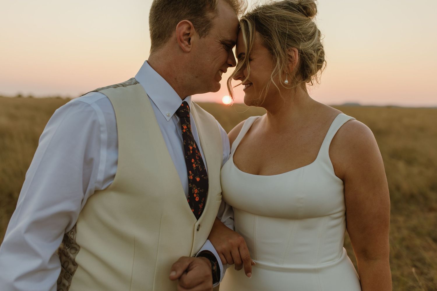 A tender moment between a couple during their sunset wedding photoshoot.