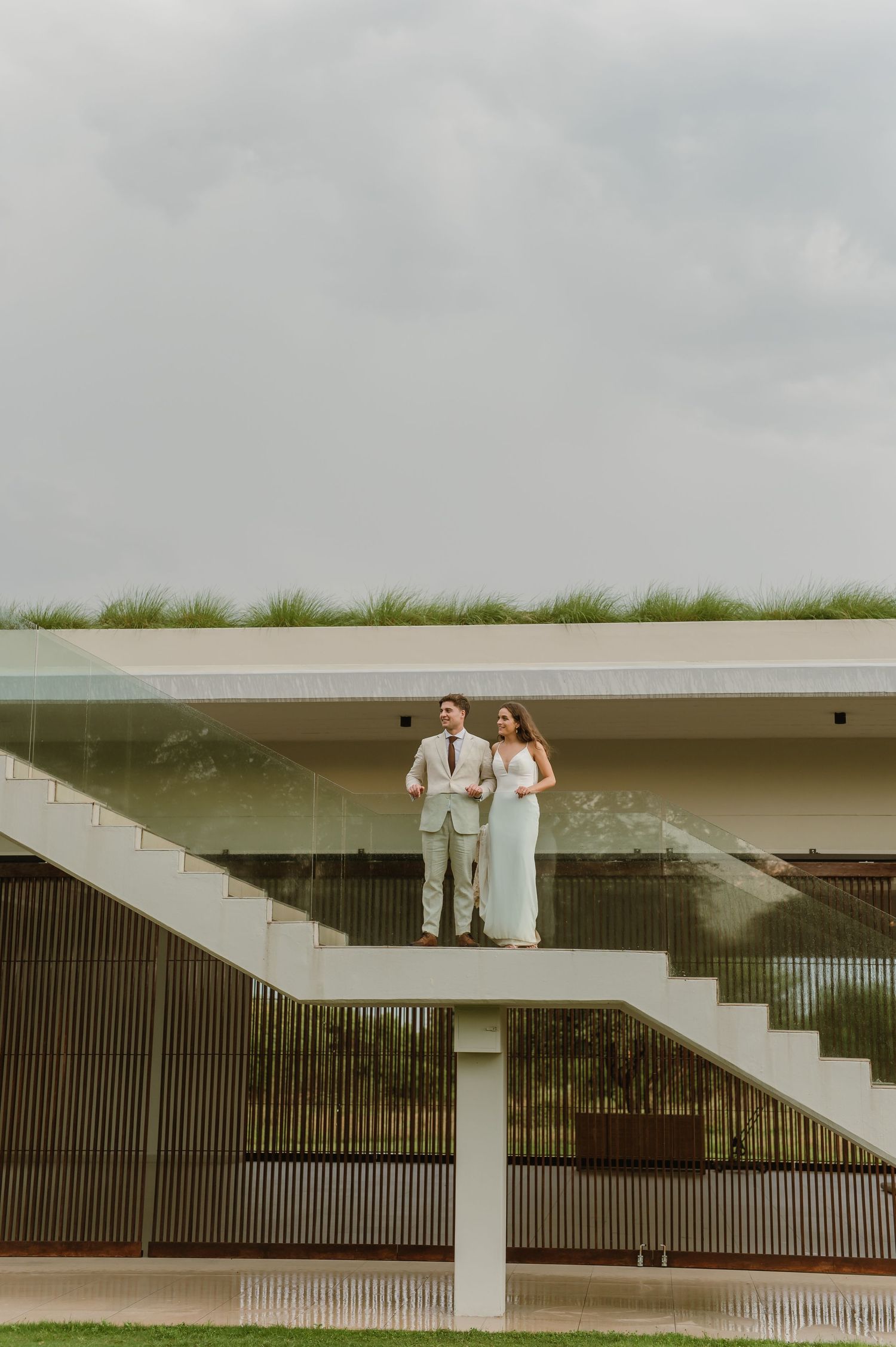 A modern architectural setting with white stairs and geometric lines for a wedding photo.