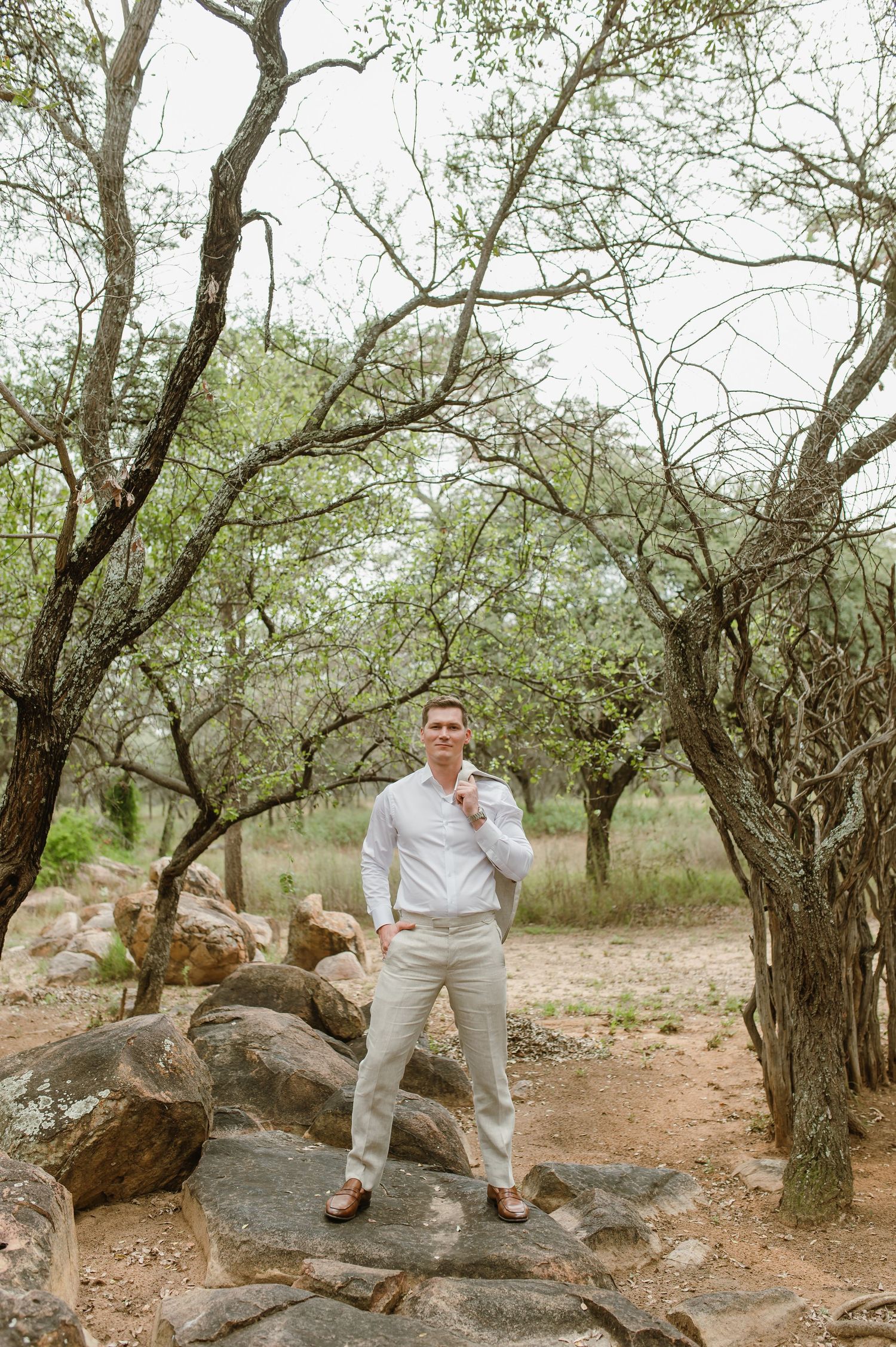A series of casual outdoor photos showing someone in a white shirt and khaki pants posing among trees and rocks.