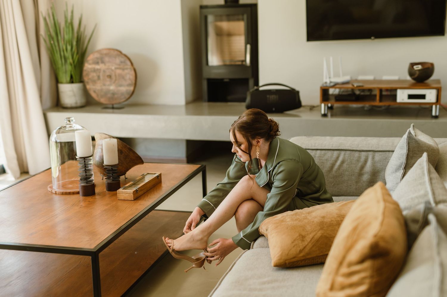 A cozy indoor scene with people relaxing on a couch in a modern living room setting.