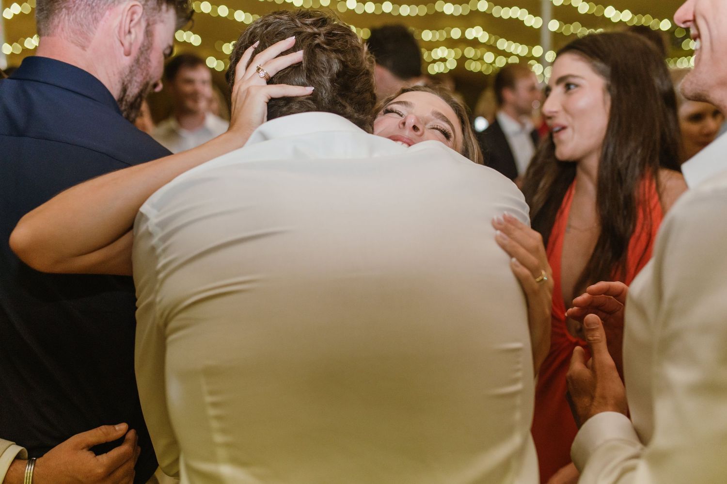 Wedding guests enjoy dancing and socializing at a lively evening reception.