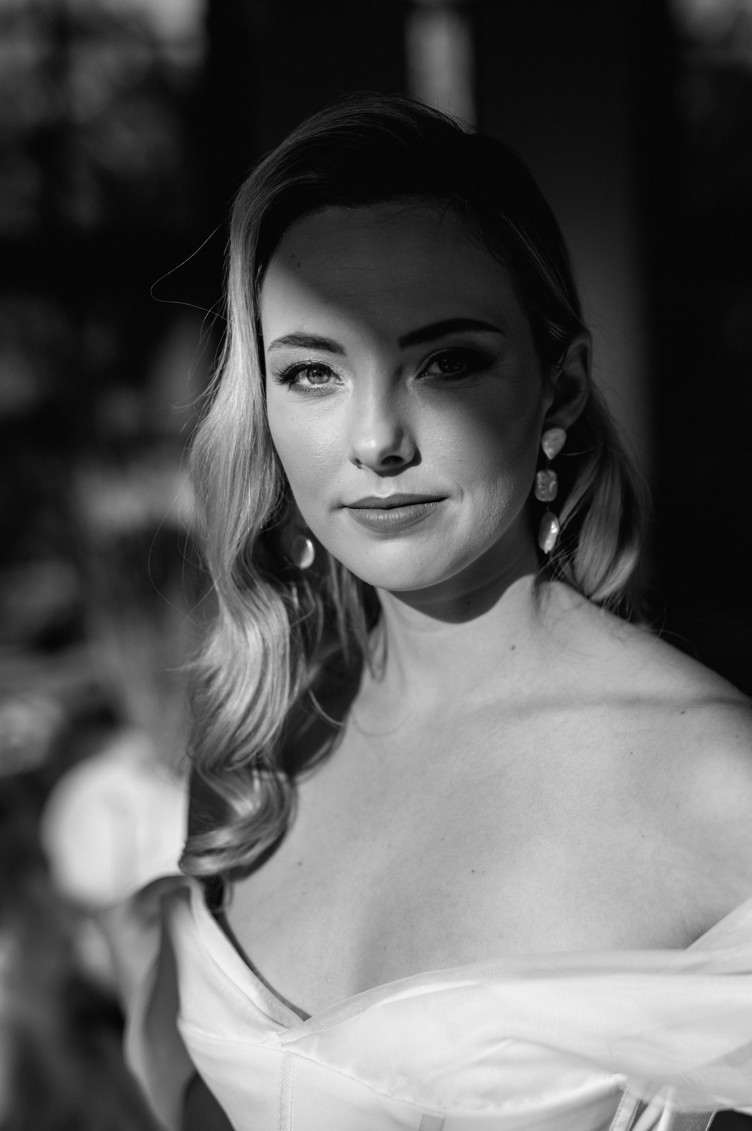 Dramatic black and white bridal portrait with elegant styling.