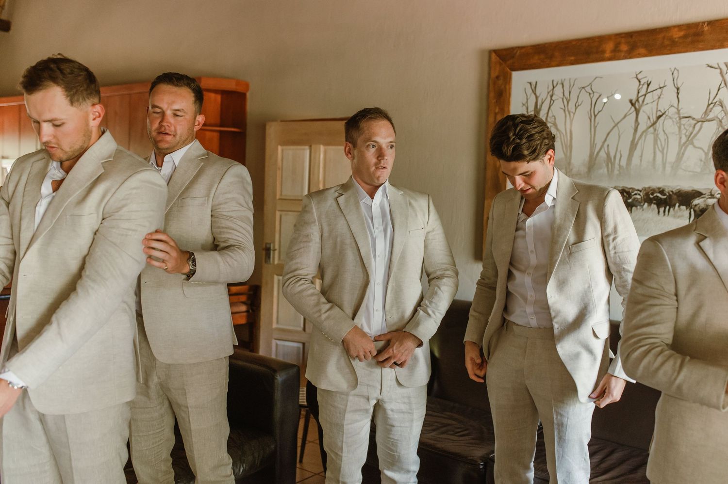 Multiple shots of formal wear preparation in a room with wooden accents and artwork.