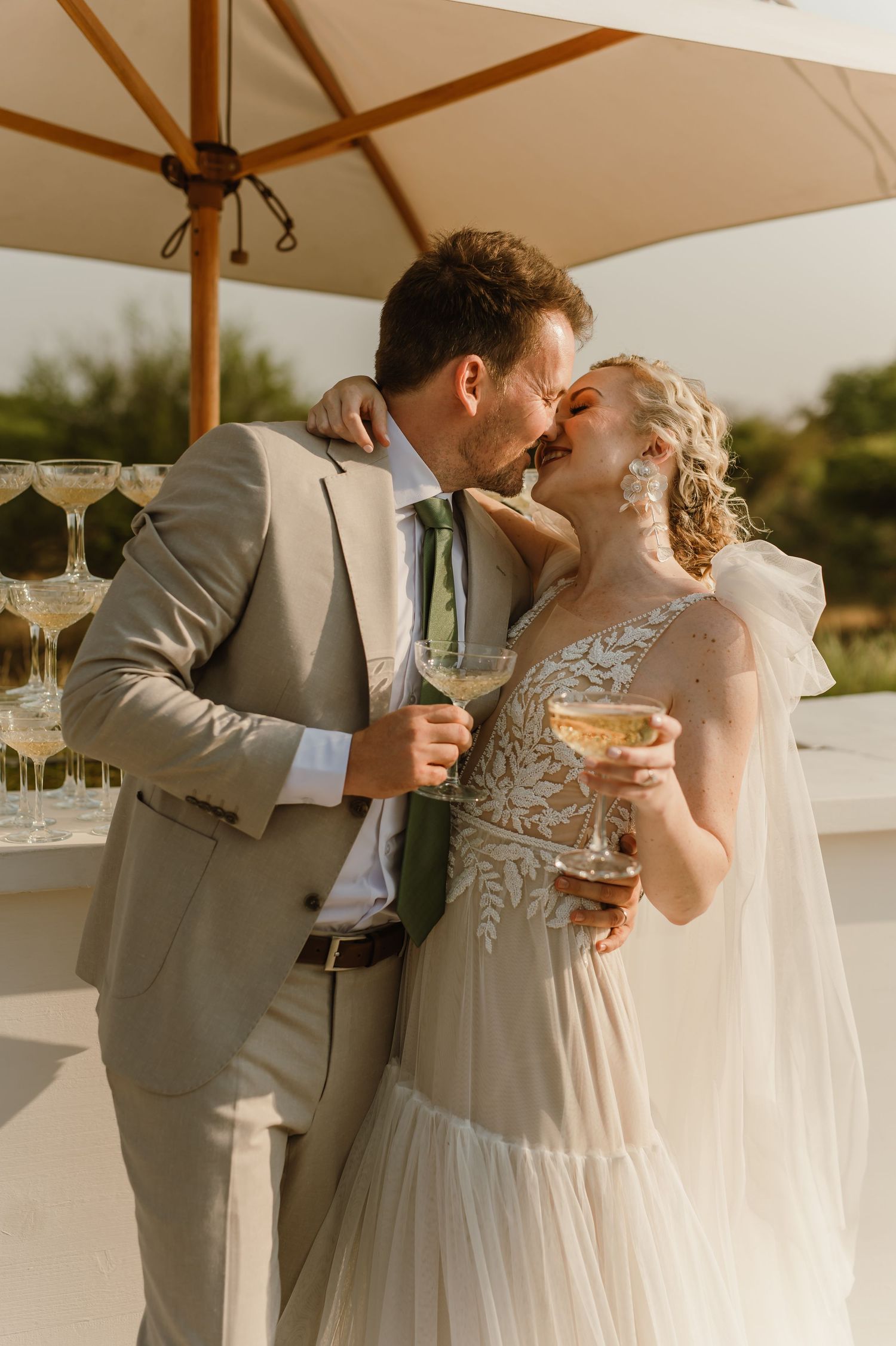 Newlyweds enjoying champagne together on their wedding day.