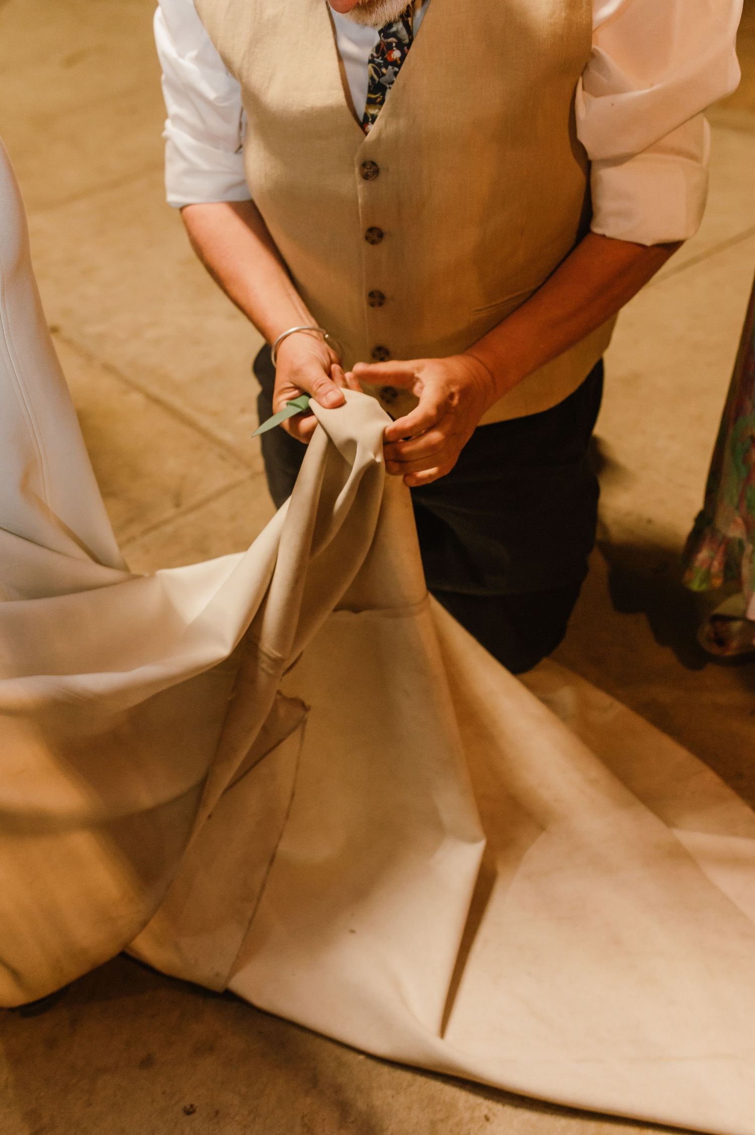 Close-up view of formal attire and wedding dress details at a reception.