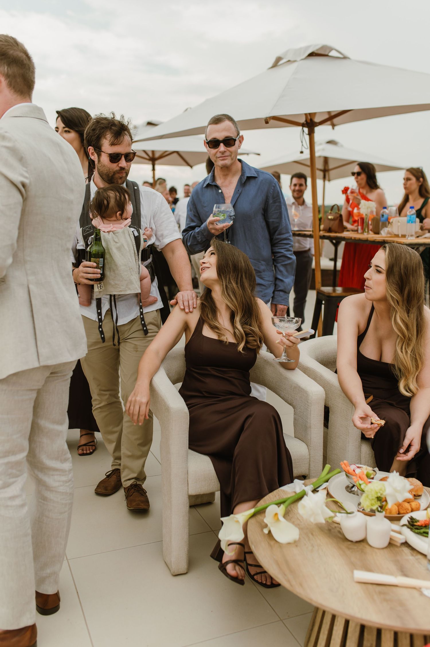 Outdoor wedding reception with guests socializing and enjoying refreshments.