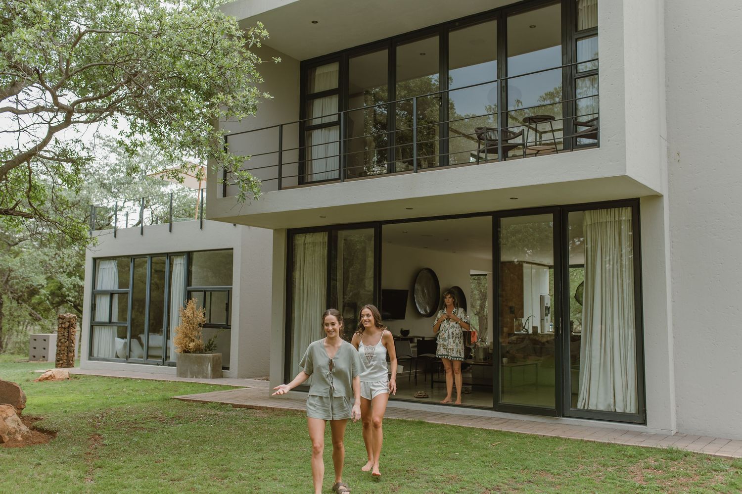 Contemporary architectural design of a white house with glass windows and balcony.