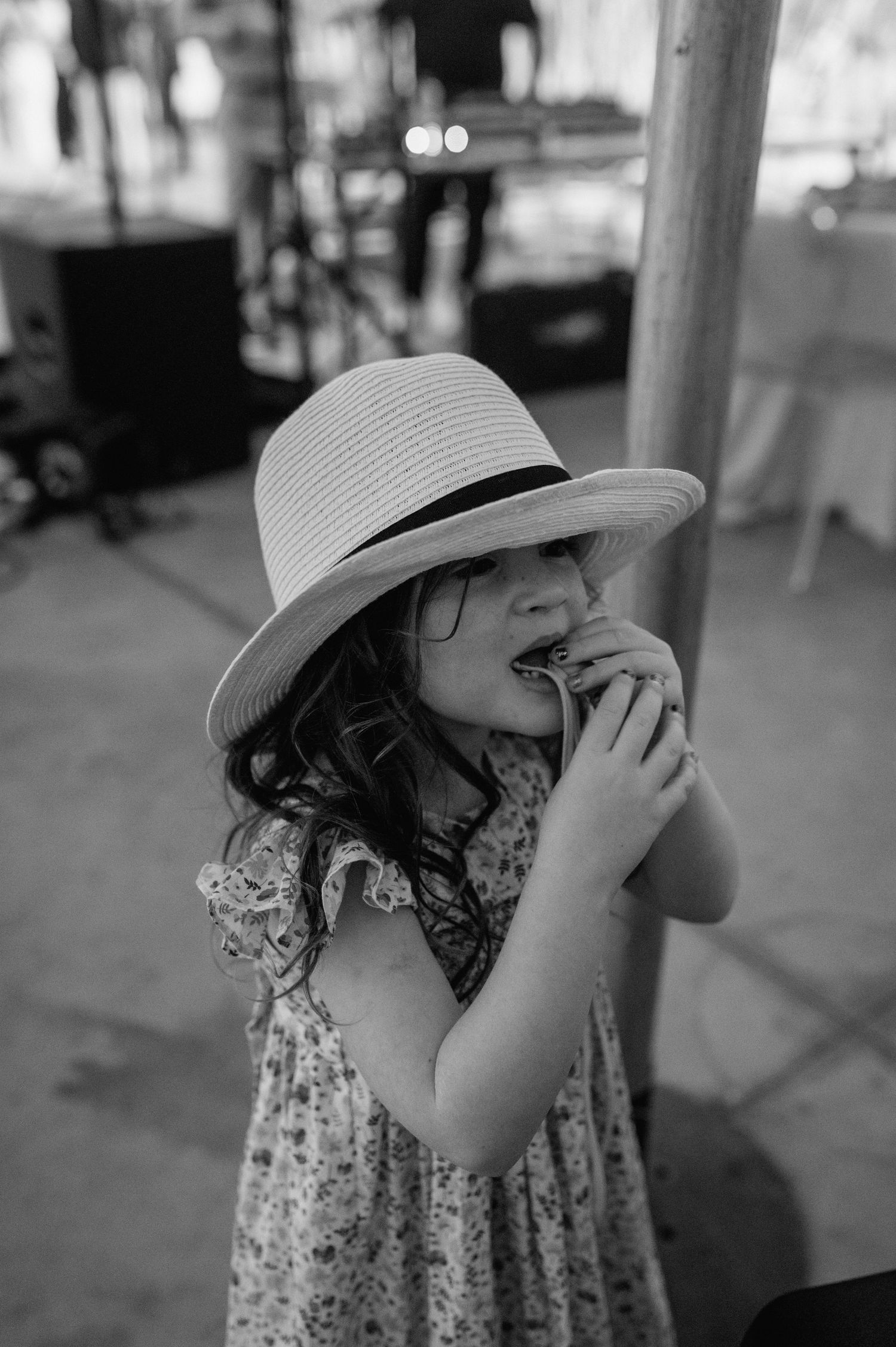A sequence of black and white photos showing someone wearing a sun hat looking upward.