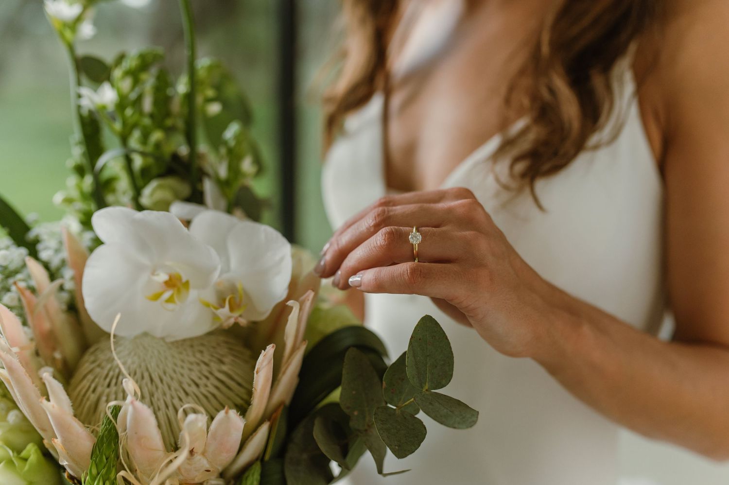 Delicate white flowers and greenery create an elegant wedding bouquet.