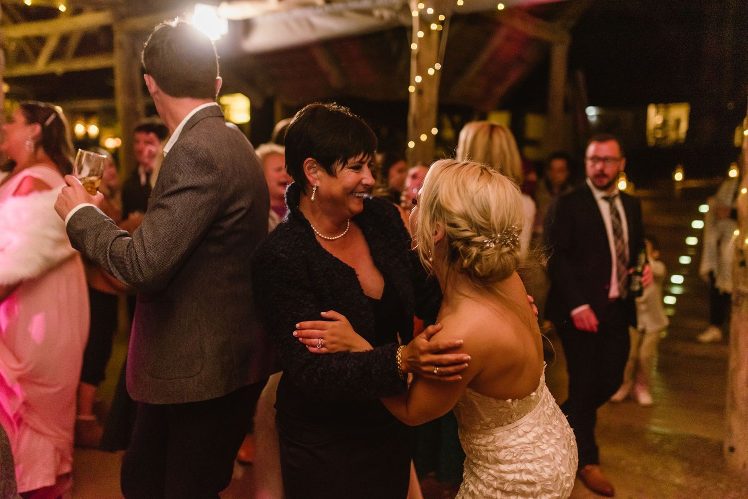 Elegant wedding reception venue with string lights creating a warm ambiance.