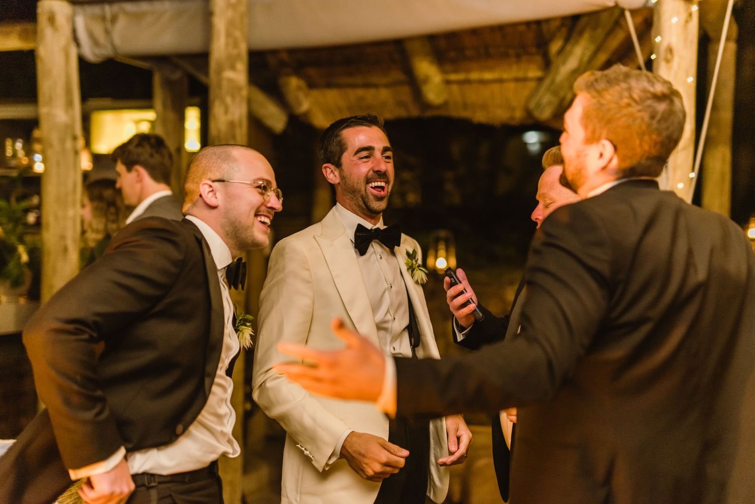 Animated conversation between guests at nighttime wedding celebration.