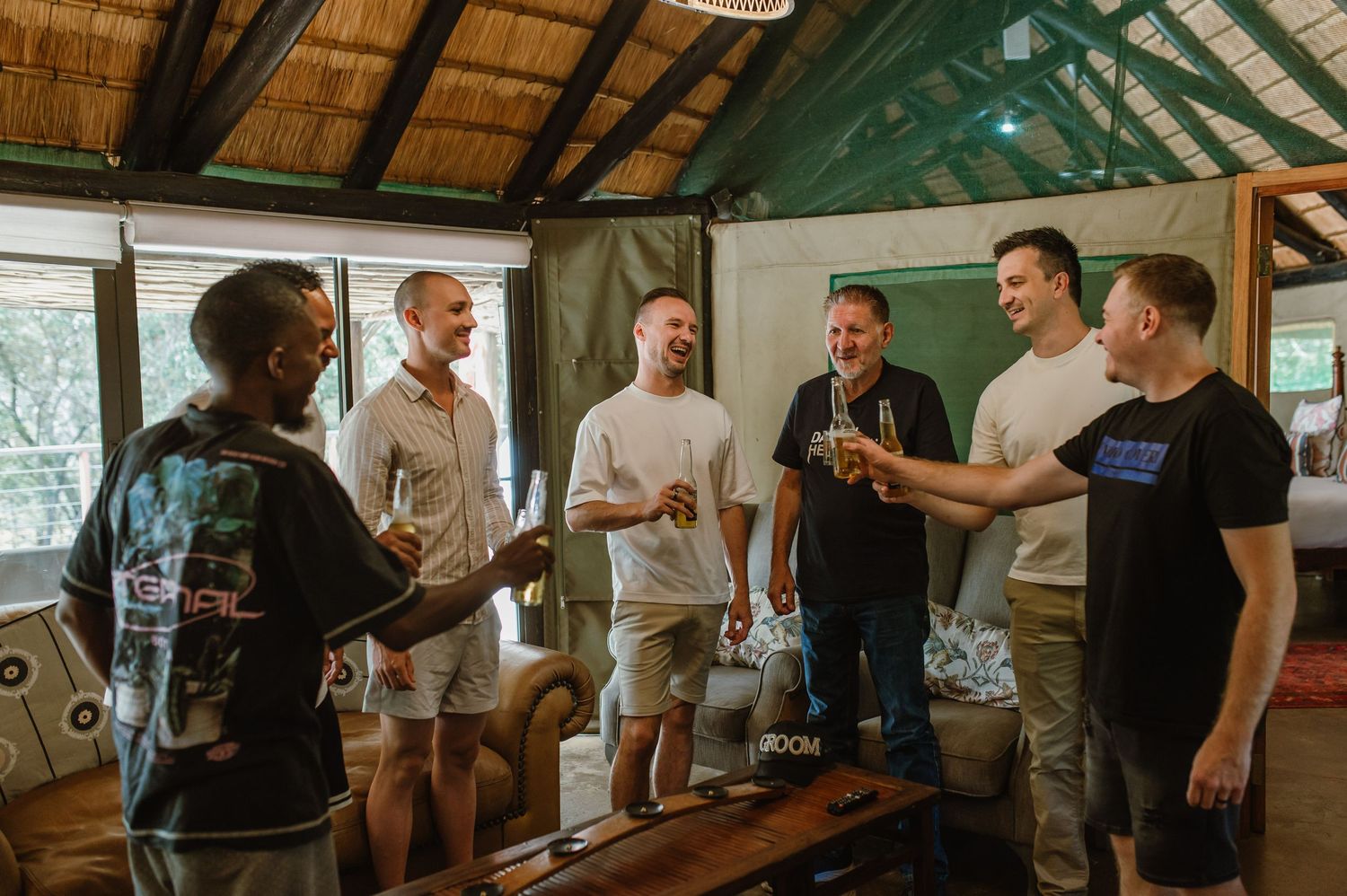 Group gathering in rustic wooden room with vaulted ceiling and natural lighting.