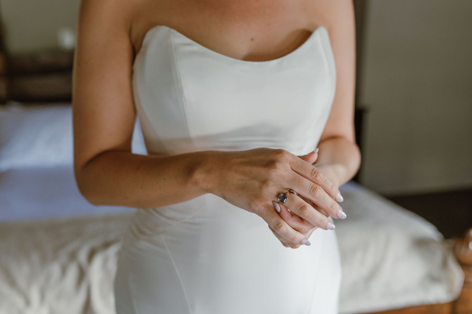 Elegant white wedding dress details shown in natural light.