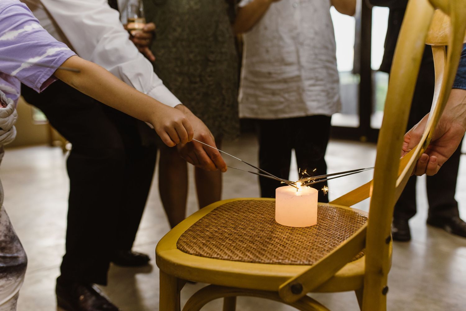 Event guests gathered around chairs with fog effects creating dramatic atmosphere.