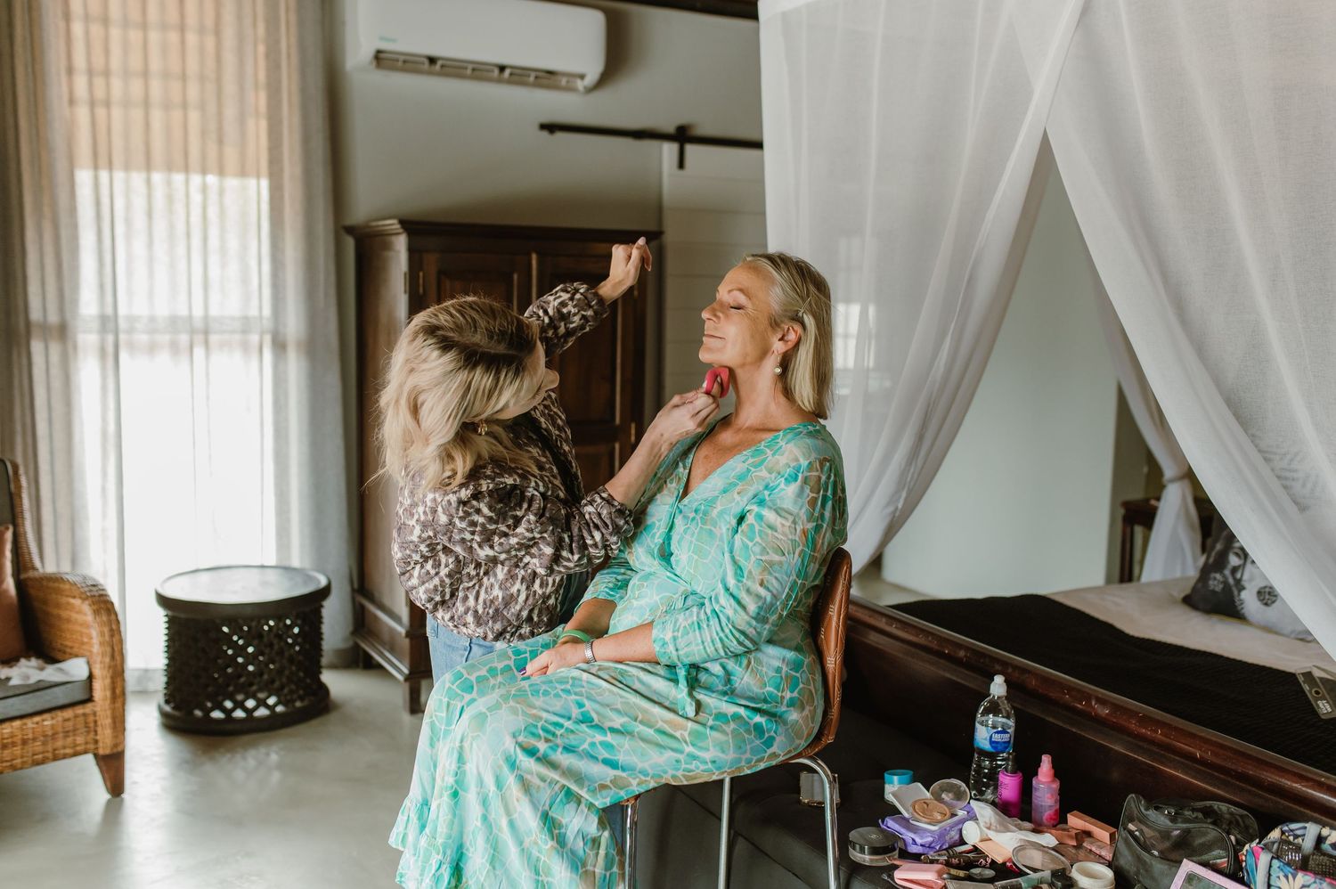Interior of bridal preparation room with white curtains and natural lighting.