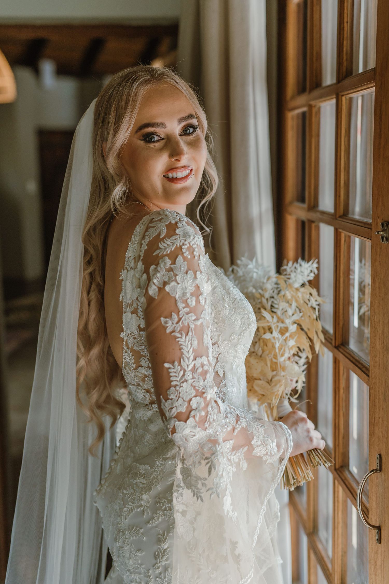 Series of bridal portraits showcasing detailed lace sleeves and veil by window light.