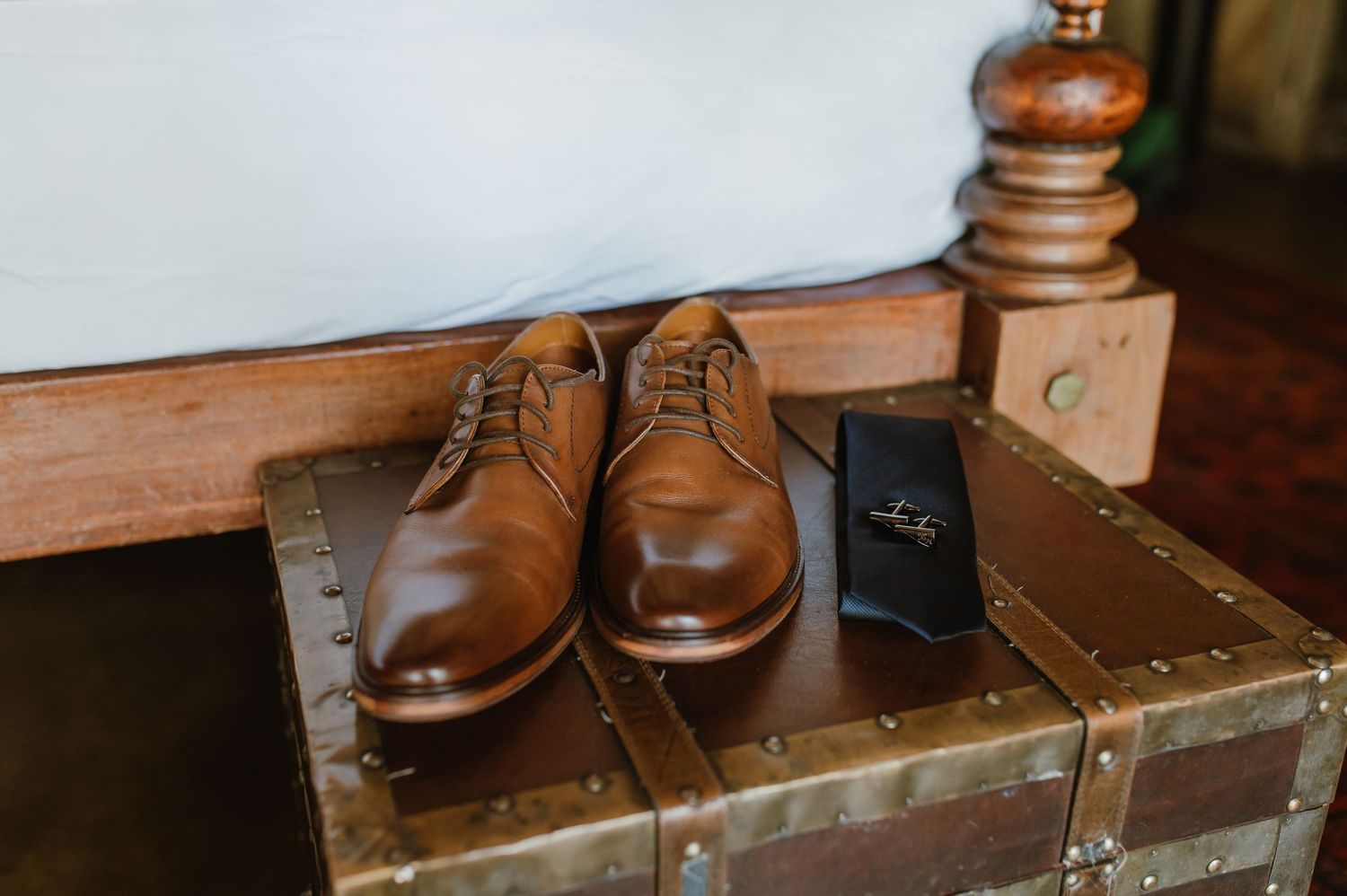 Collection of brown leather dress shoes arranged on wooden surface.