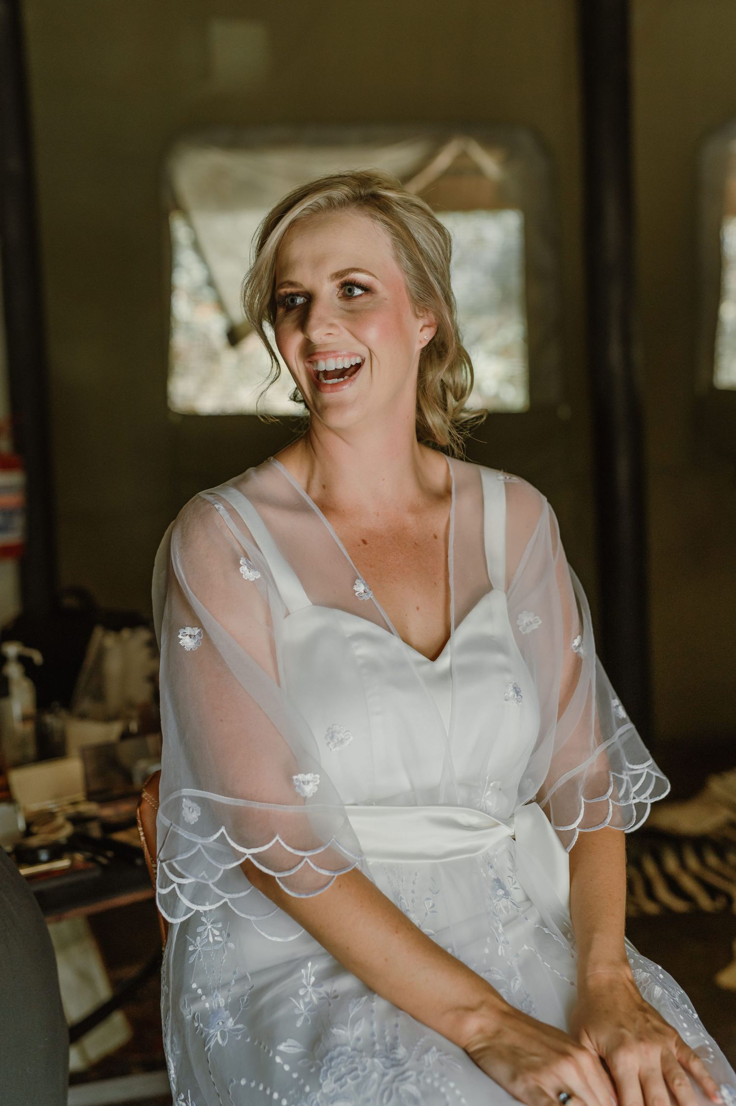 Joyful pre-wedding moments in white dress with delicate lace details.