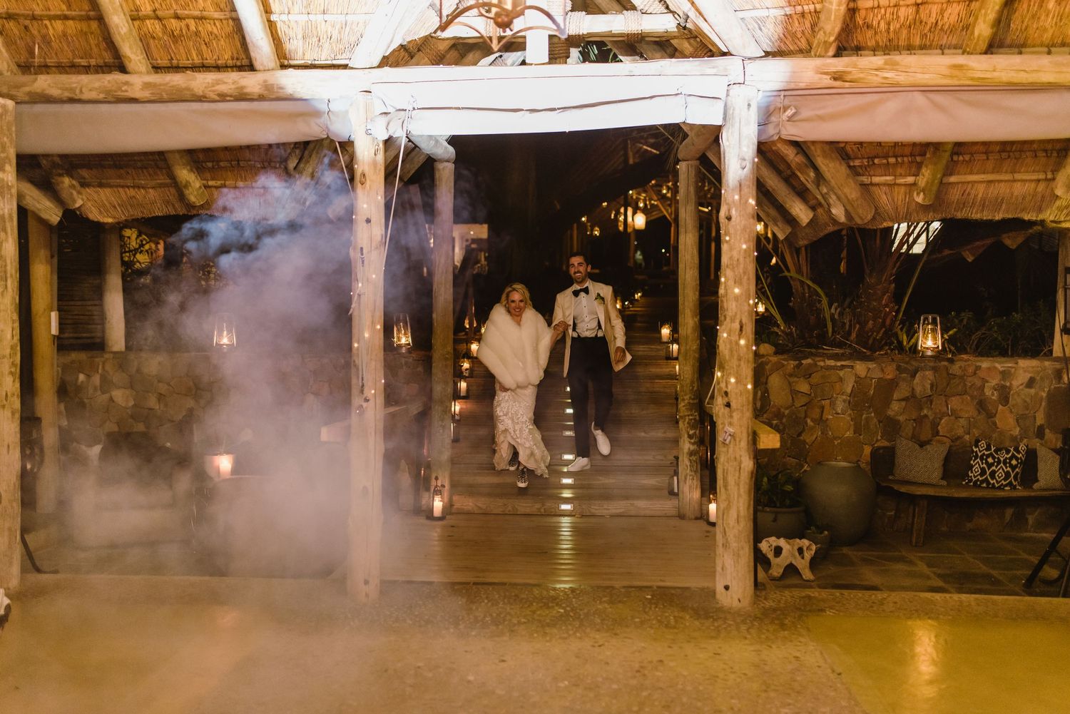 Rustic venue interior with atmospheric lighting and fog effects.