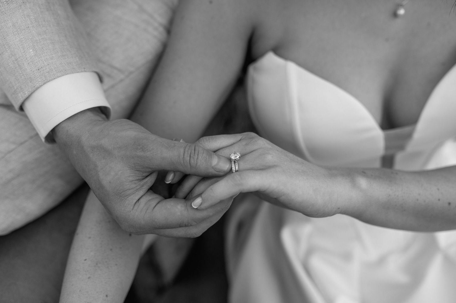 A sequence of black and white photos showing hands holding and examining a newborn baby.