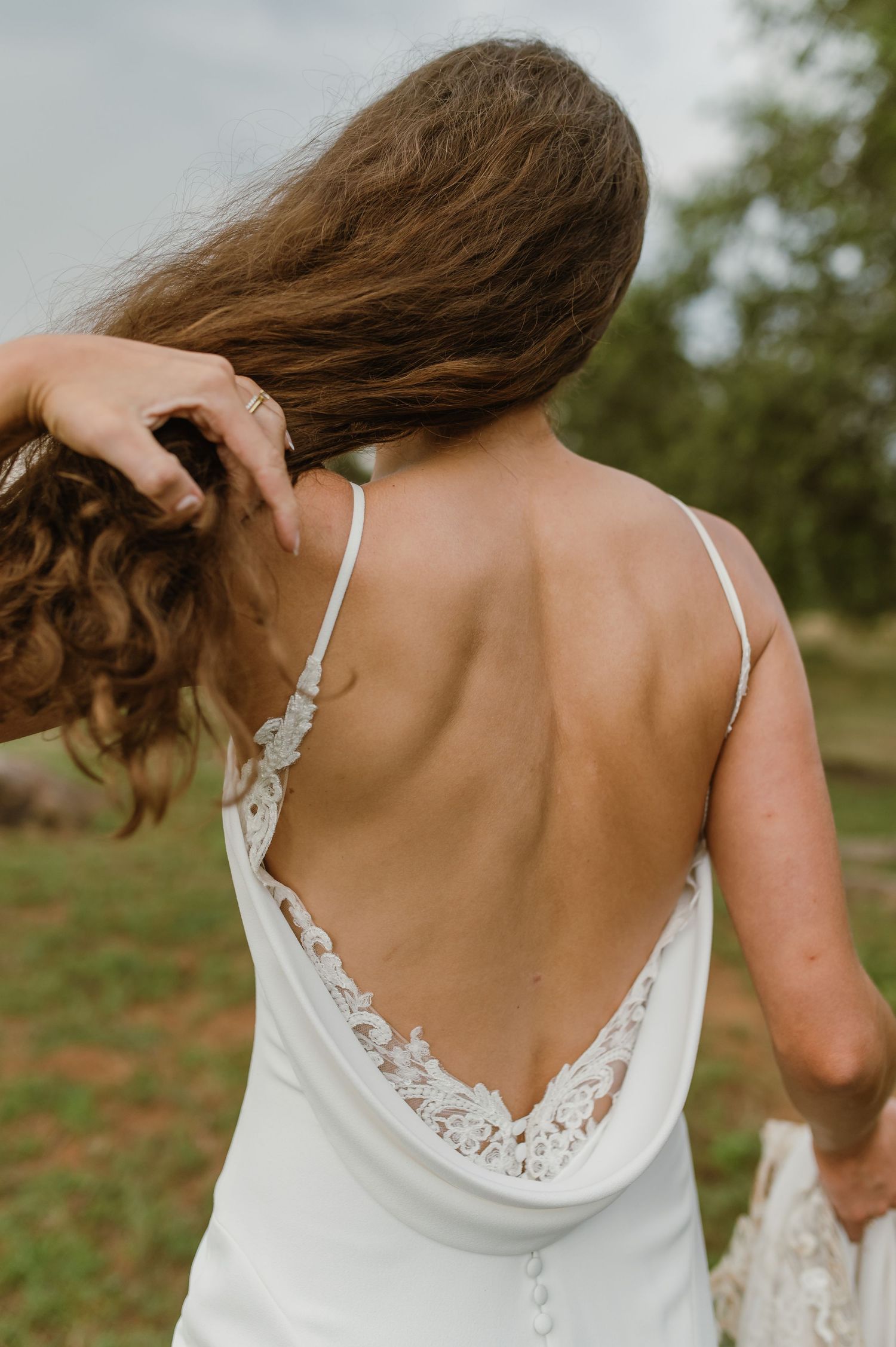 Close-up detail of a wedding dress's delicate lace back design.